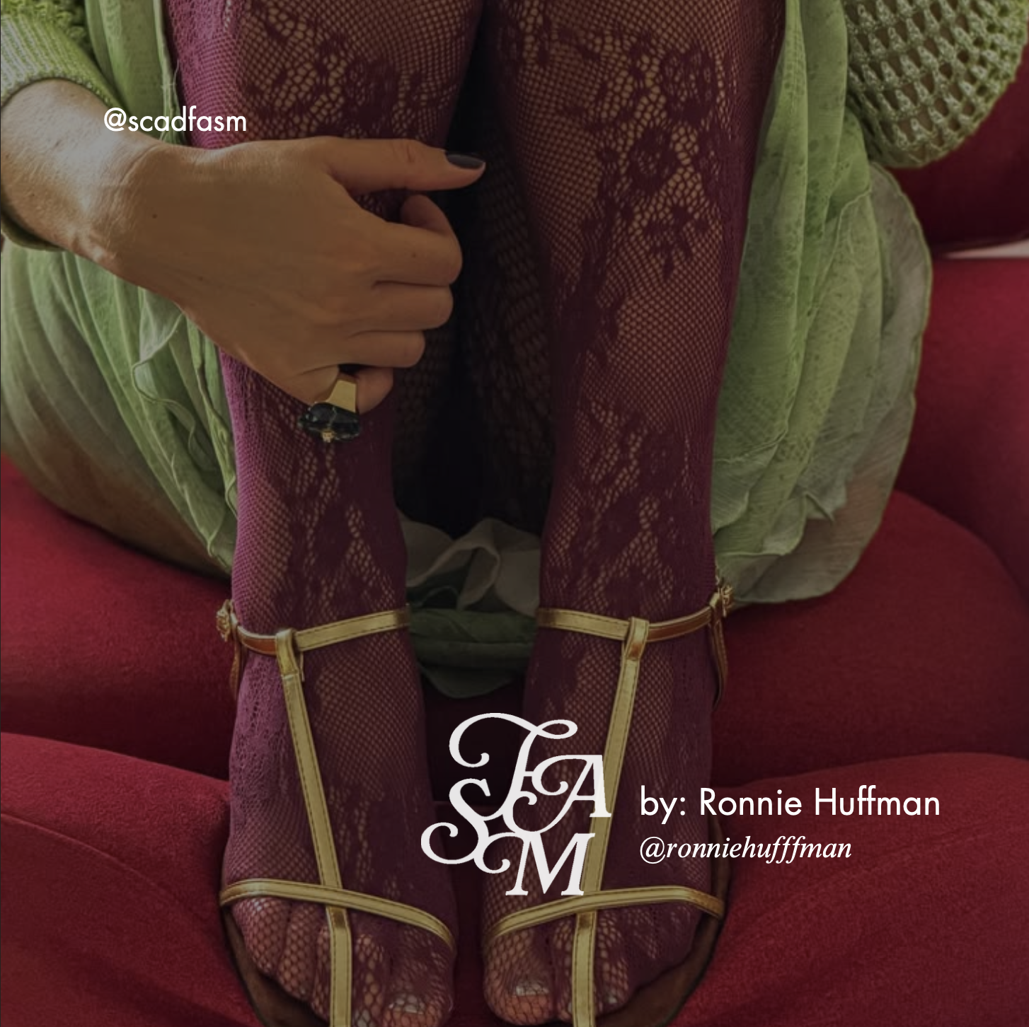 Close-up of a person wearing burgundy lace tights and gold strappy heels, seated on a red couch in a green robe.