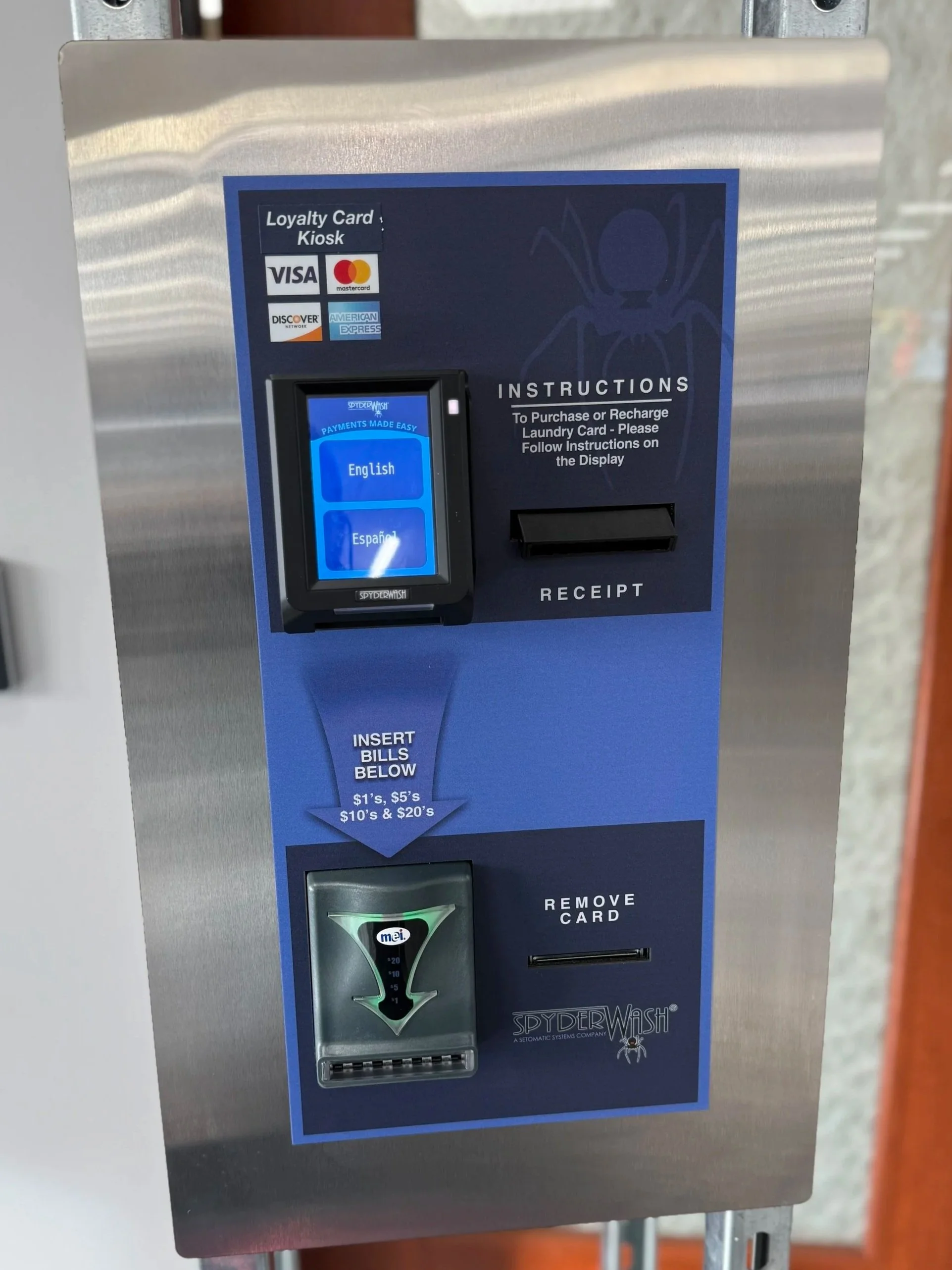 Loyalty card kiosk with a touchscreen for payment, a receipt slot, and a bill insert slot. The kiosk is labeled 'SpyderWash' and displays instructions for laundry card recharges.