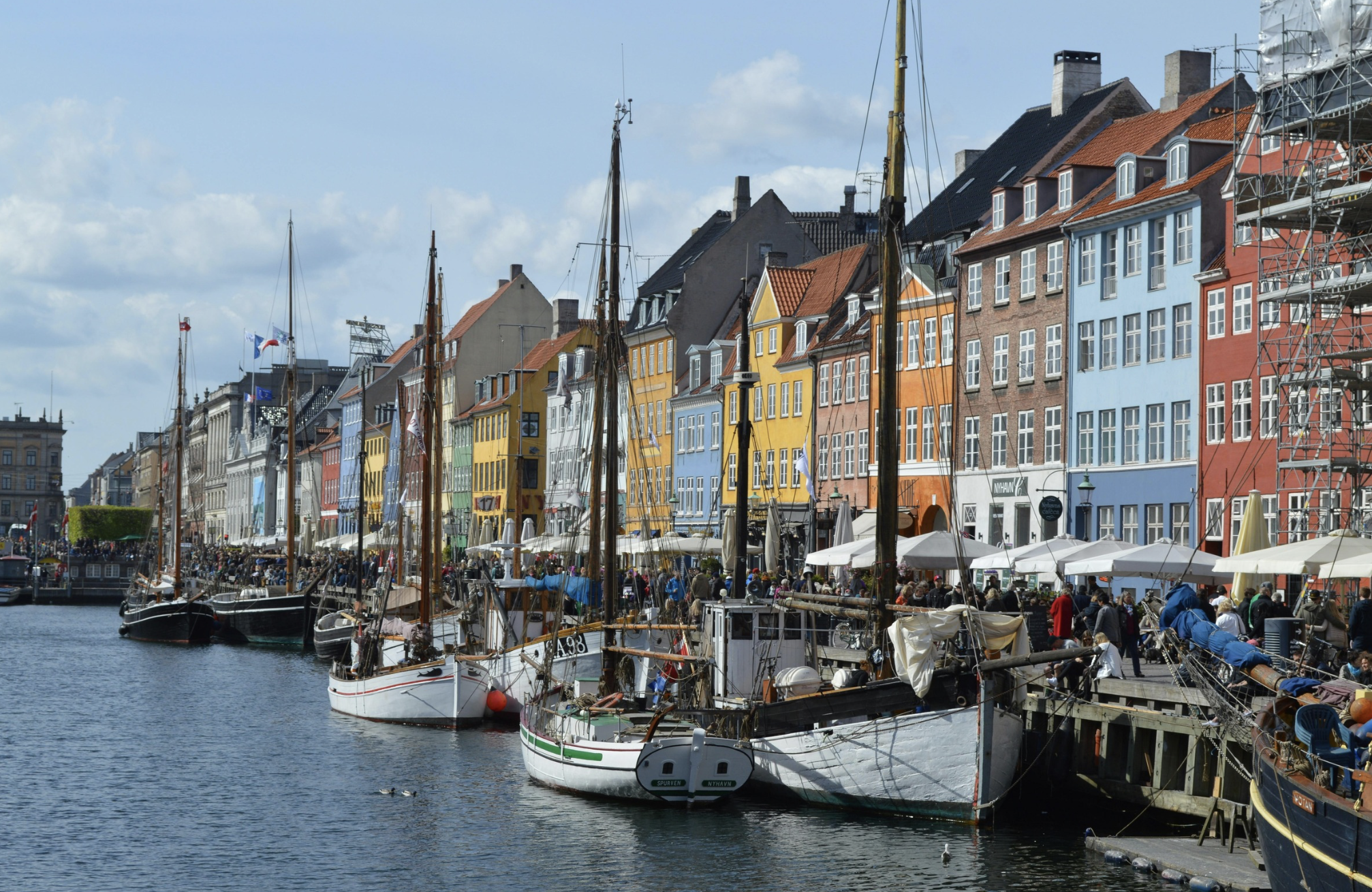 colorful building facades and sailing vessels at the Nyhavn waterfront in Copenhagen, Denmark