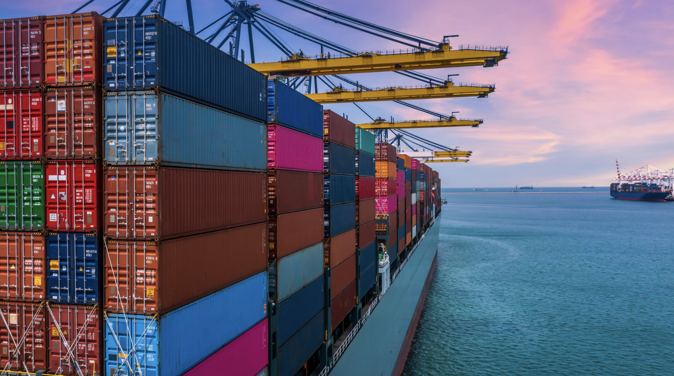 Colorful display made of shipping containers stacked on a port overlooking water