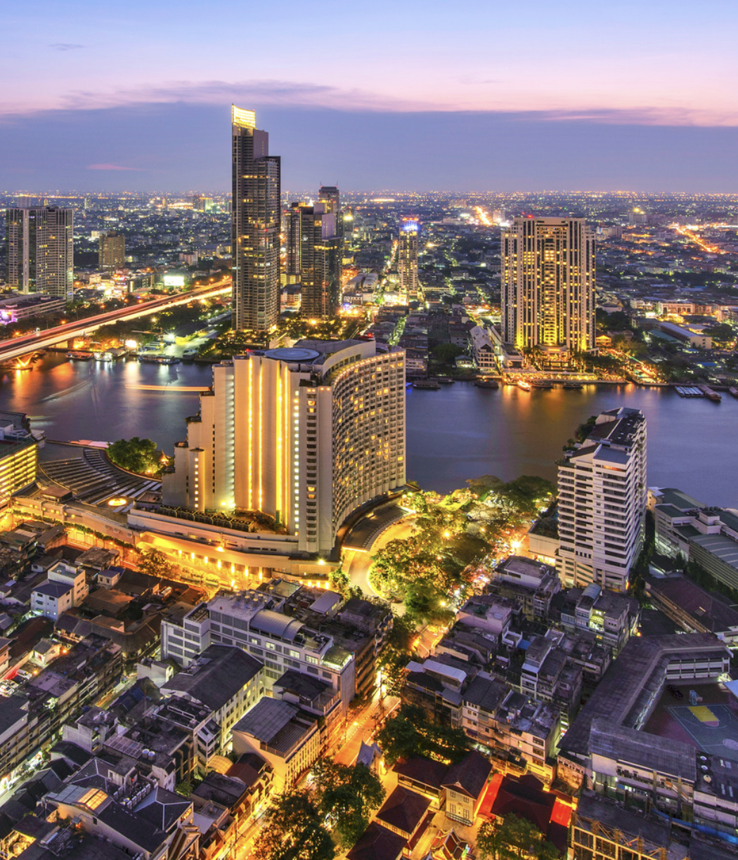 An illuminated aerial view of the Chao Preya River skyline, Bangkok, Thailand