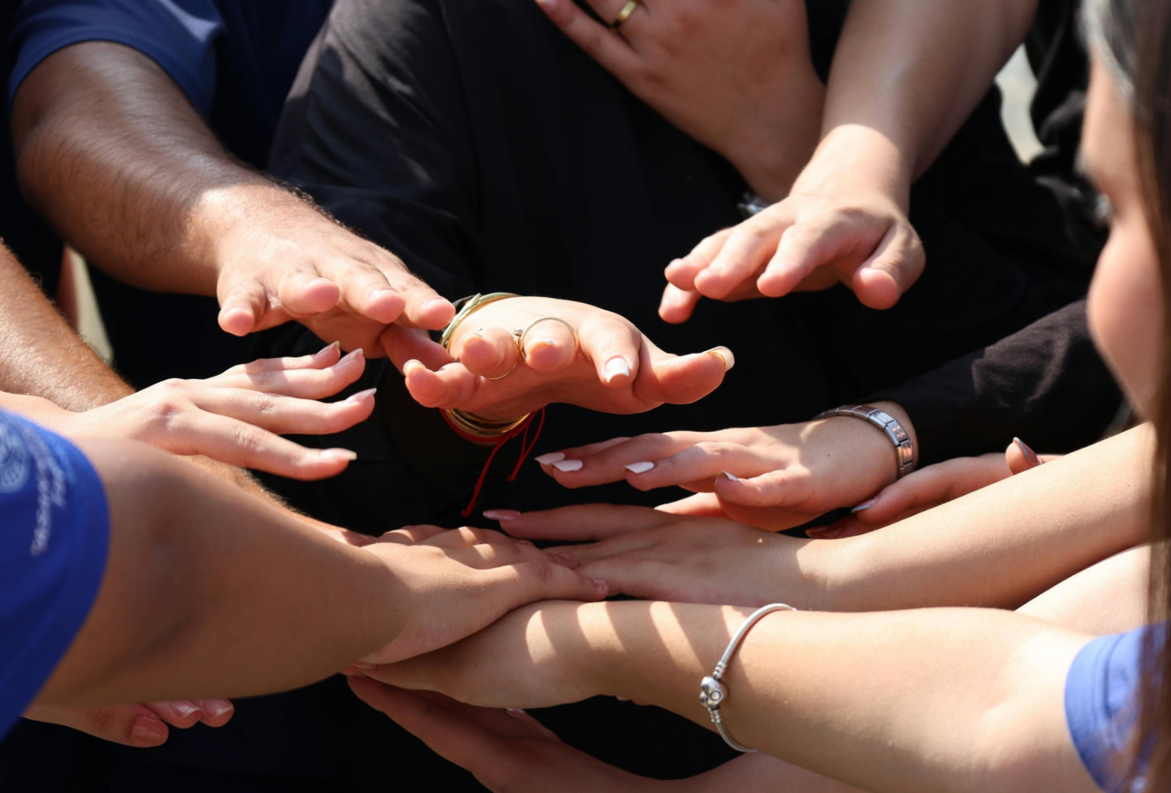 Photo of outstretched hands extended toward each other in teamwork gesture