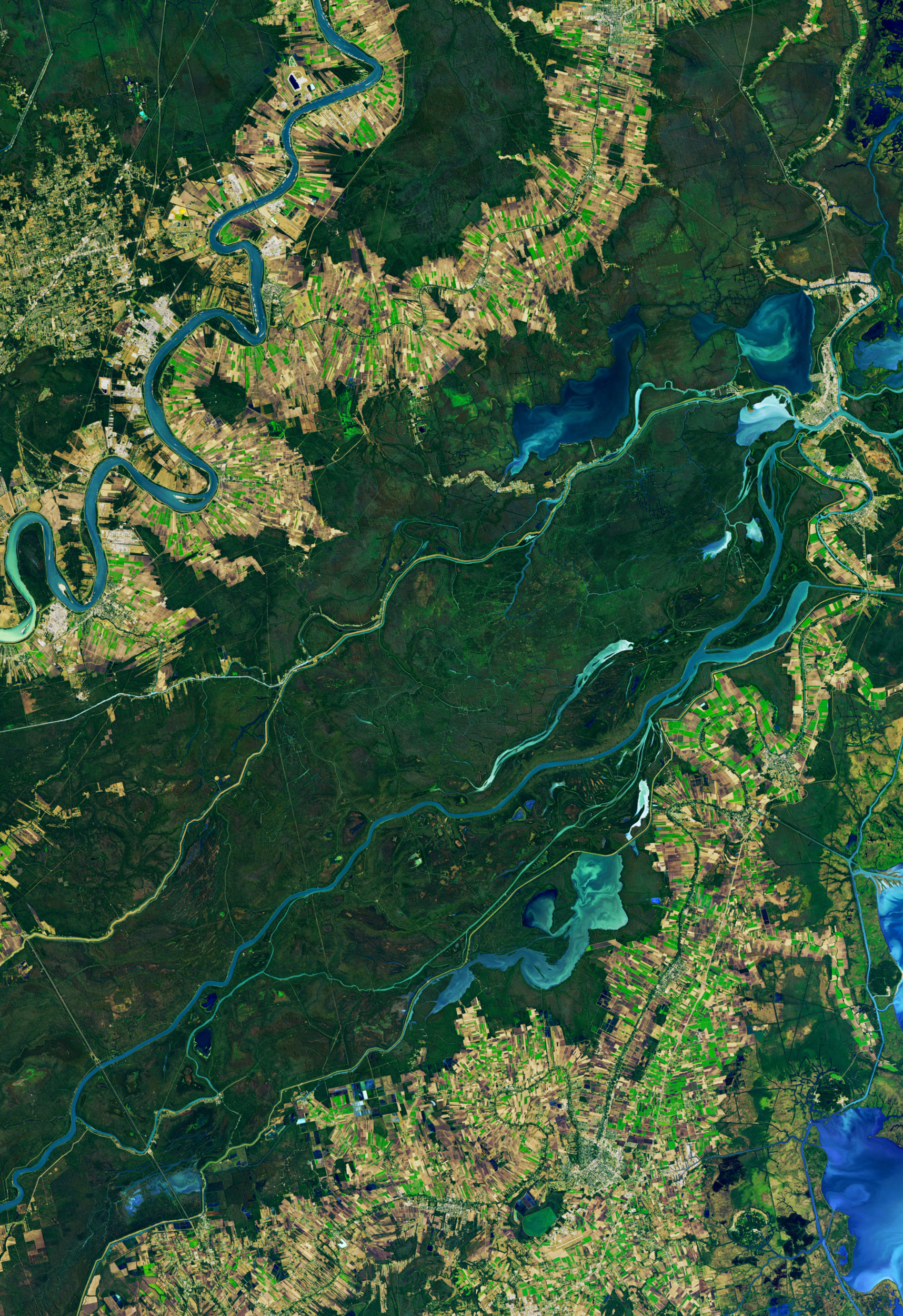 Aerial view of multiple rivers and riverside settlement and development