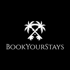 Logo with two palm trees and crossed keys above the text 'BookYourStays' on a black background.