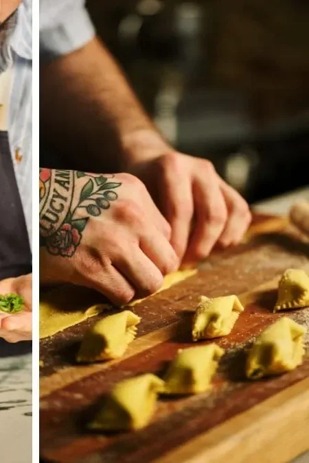 Person shaping small dough portions on a wooden surface, with a tattooed arm visible.