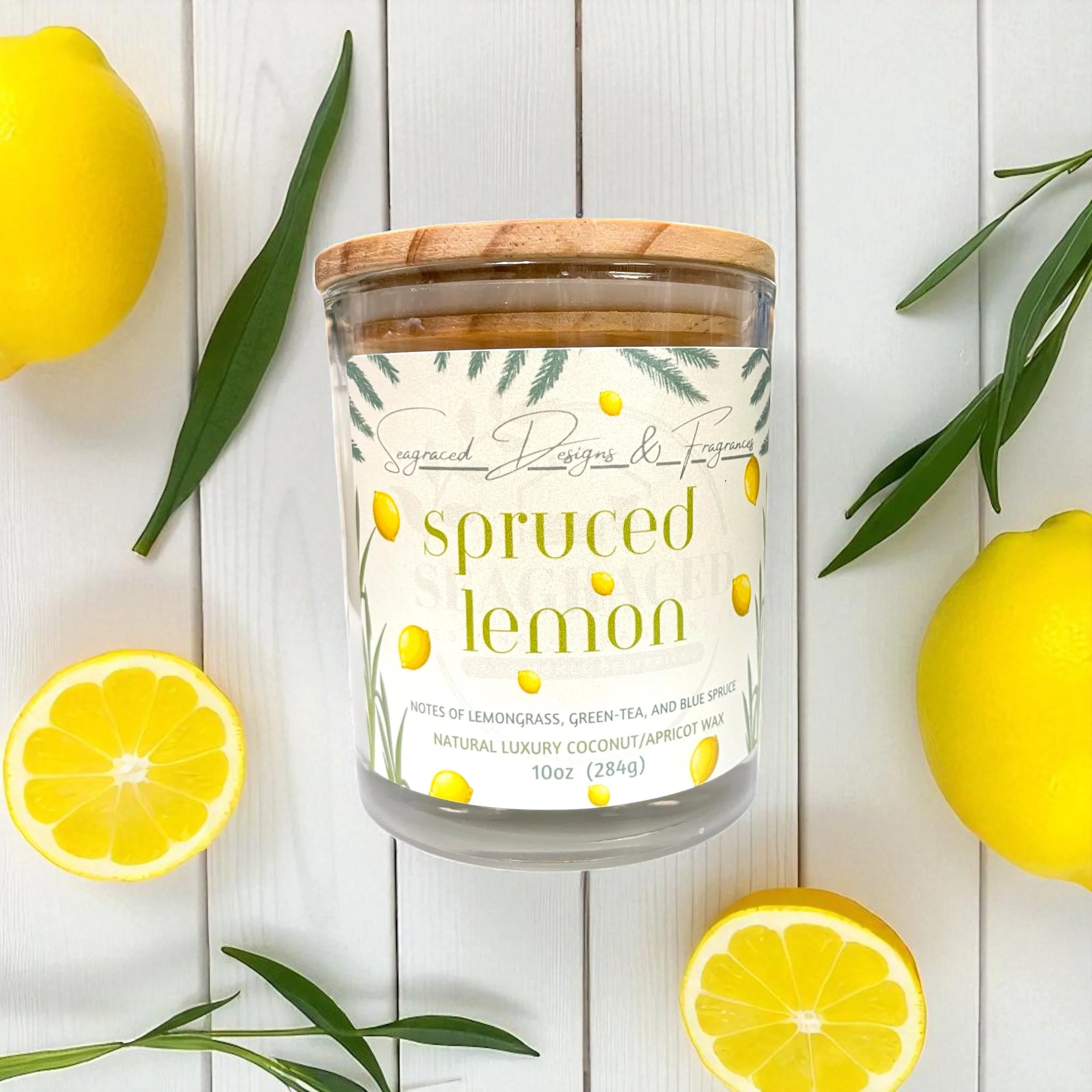A jar of lemon-scented candle with a wooden lid, surrounded by sliced lemons and green leaves on a white wooden surface.