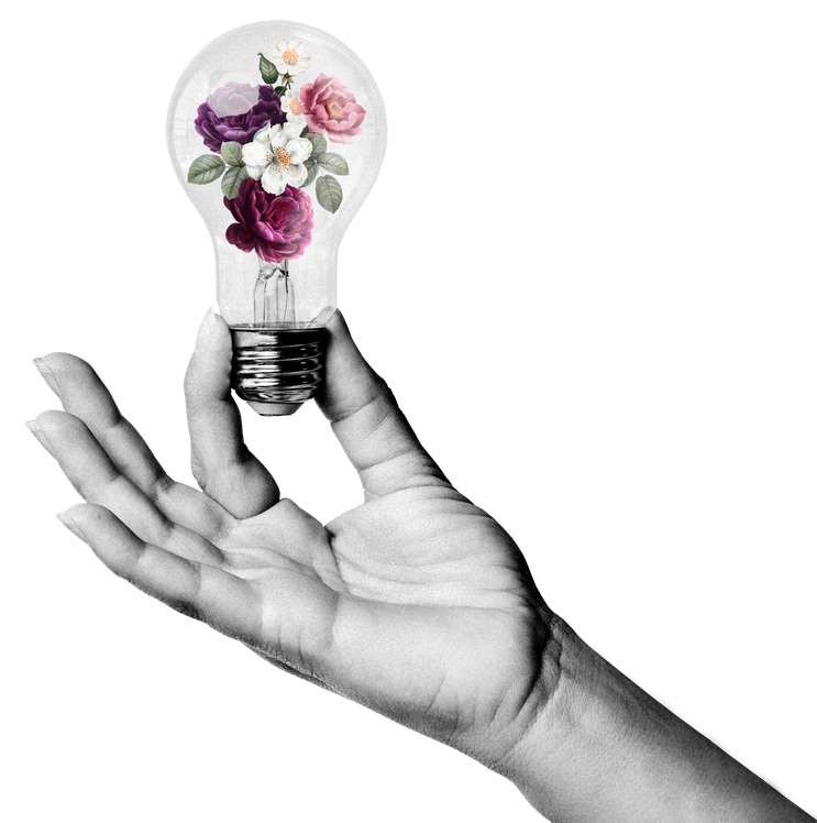 A black and white hand holding a lightbulb with flowers inside