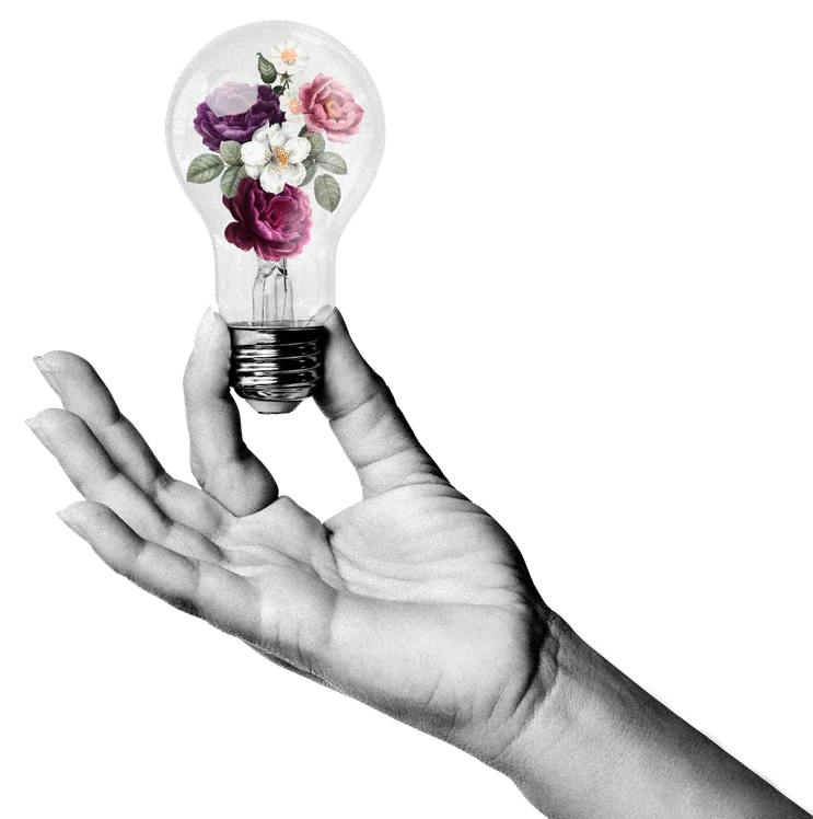 Hand holding a old style light globe filled with flowers