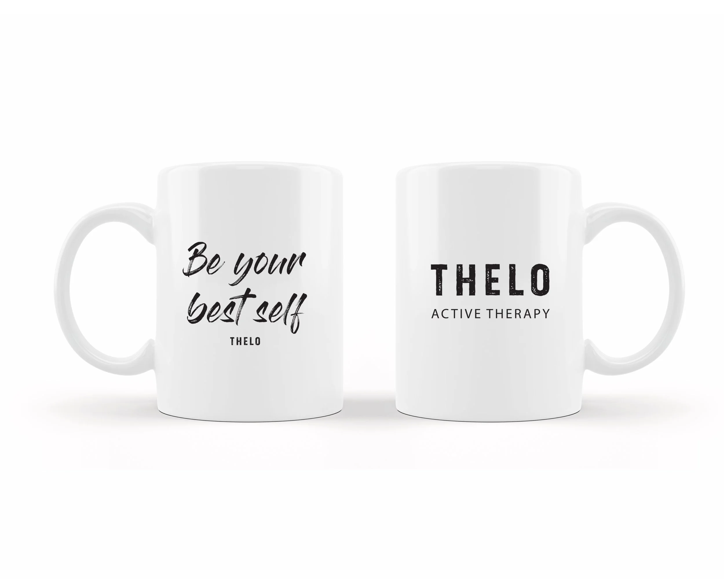 Two white ceramic mugs with black text, one reading "Be your best self THELO" and the other "THELO ACTIVE THERAPY," against a plain white background.