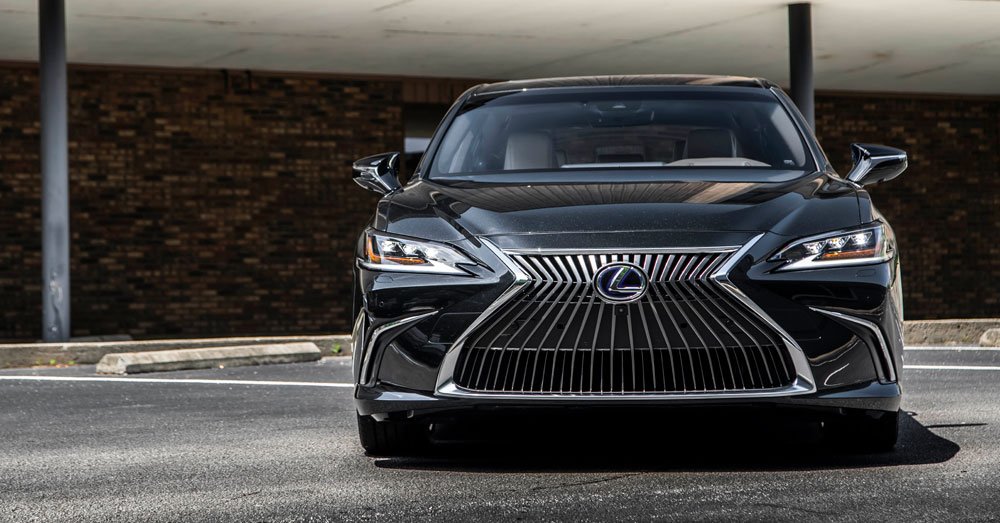 Front view of a black Lexus sedan parked in an outdoor parking lot.