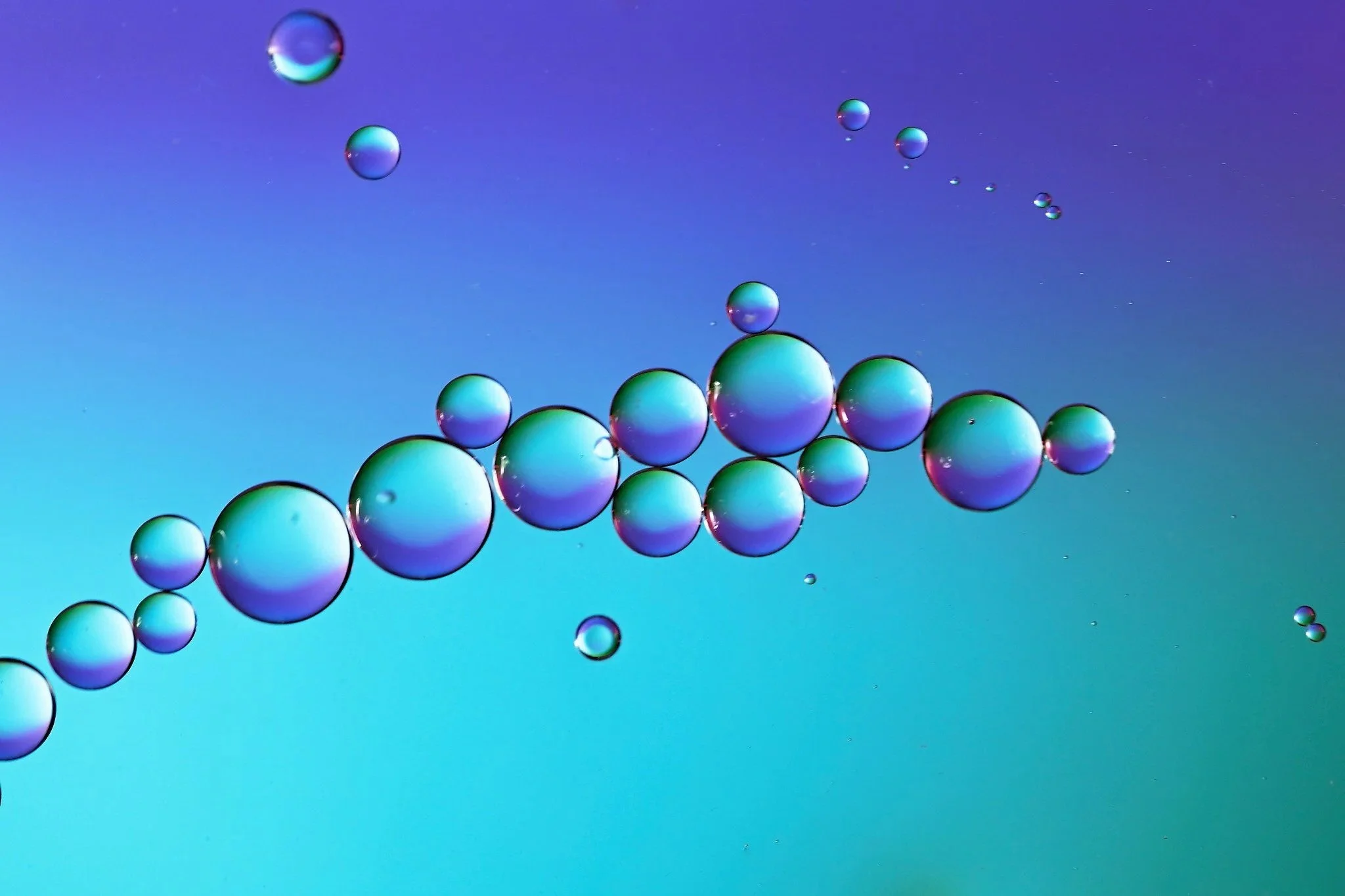 Colorful bubbles floating on a gradient blue and purple background.