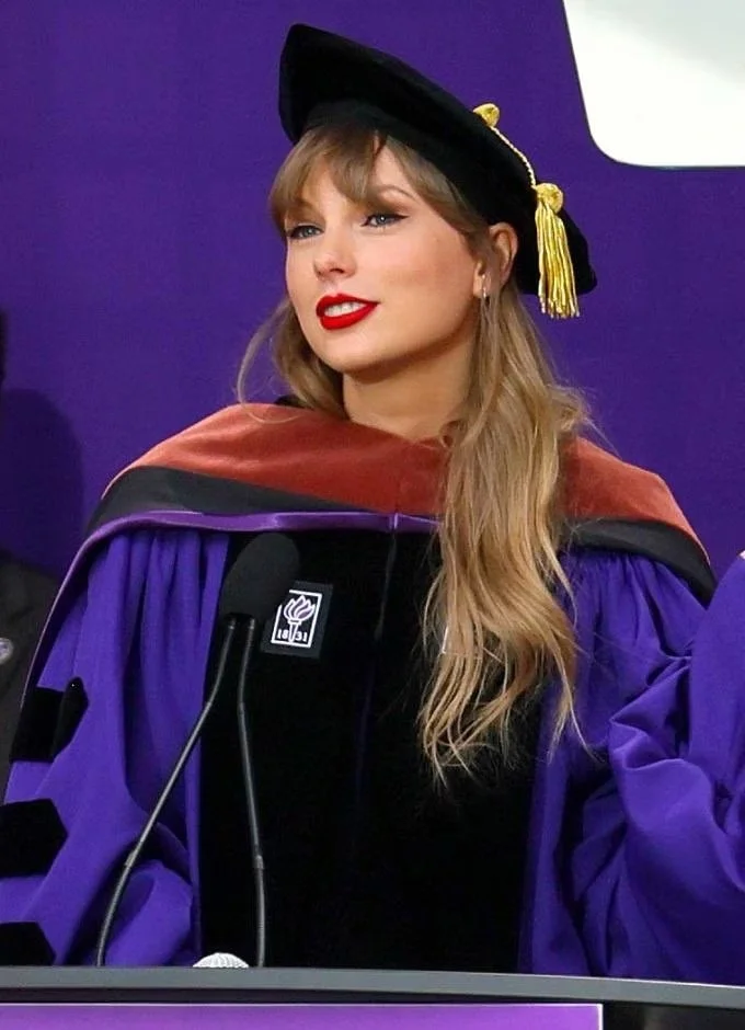 Taylor Swift giving her commencement speech at New York University. She is wearing graduation regalia.