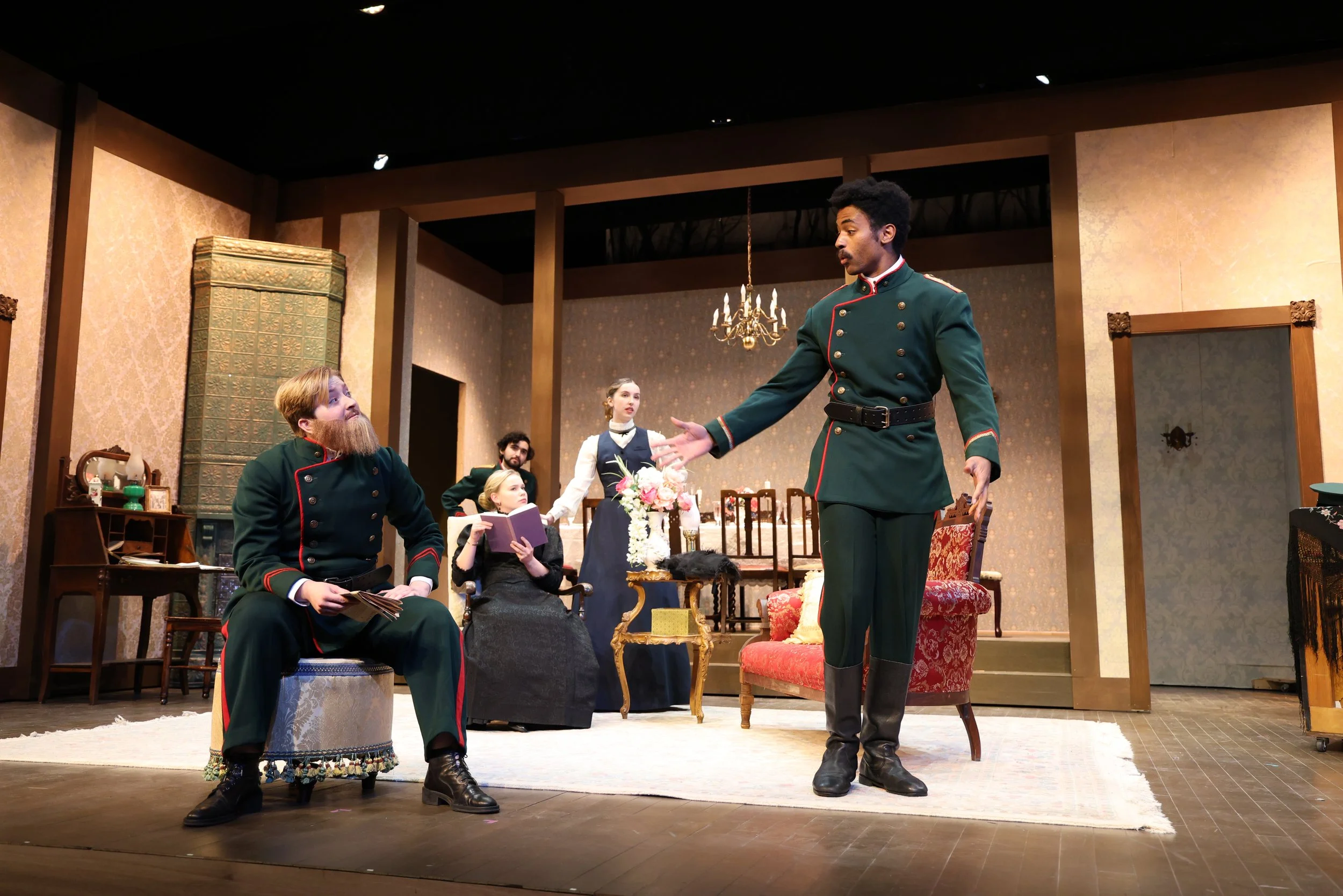 Iyanu Olukotun as Tuzenbach in an ensemble scene with Chebutykin, Solyony, Masha, and Olga in Three Sisters, photographed by Frank Chen