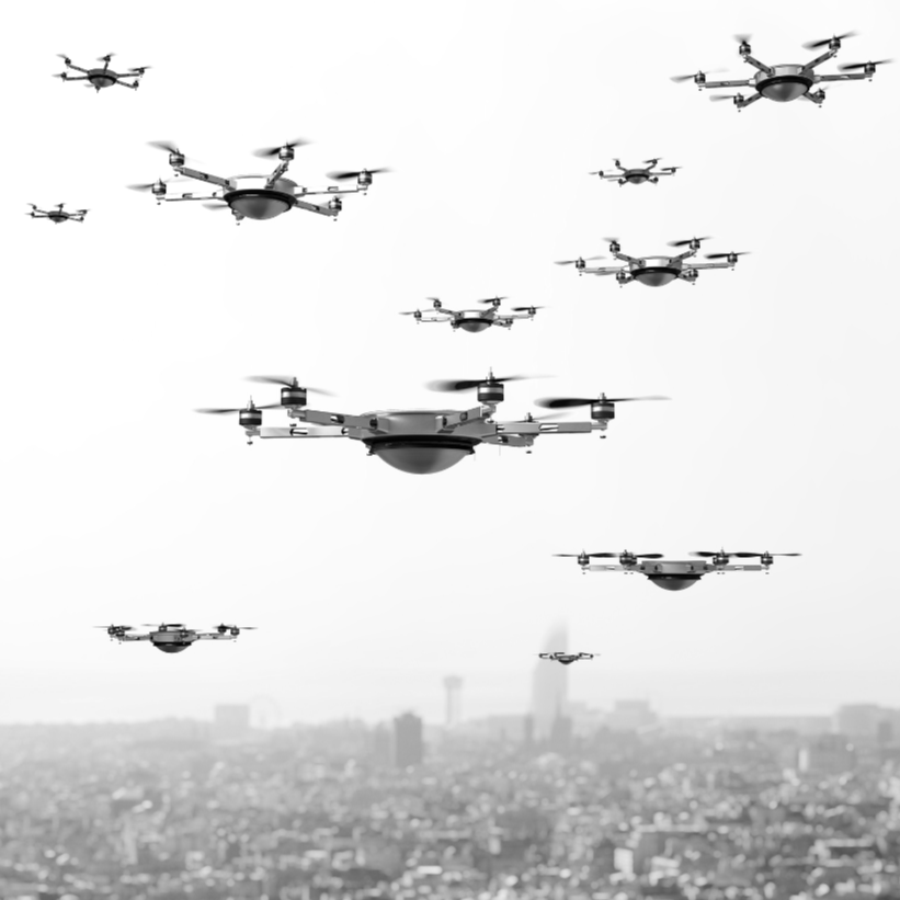 Multiple drones flying over a city skyline in black and white.