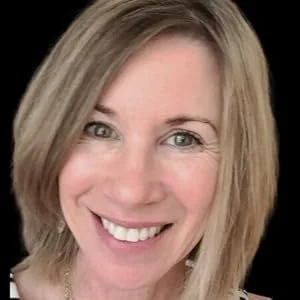 Close-up of a woman with shoulder-length blonde hair smiling at the camera.