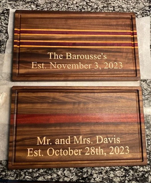 Two engraved wooden plaques with engraved gold-colored text, one reading "The Barousse's Est. November 3, 2023" and the other reading "Mr. and Mrs. Davis Est. October 28th, 2023."