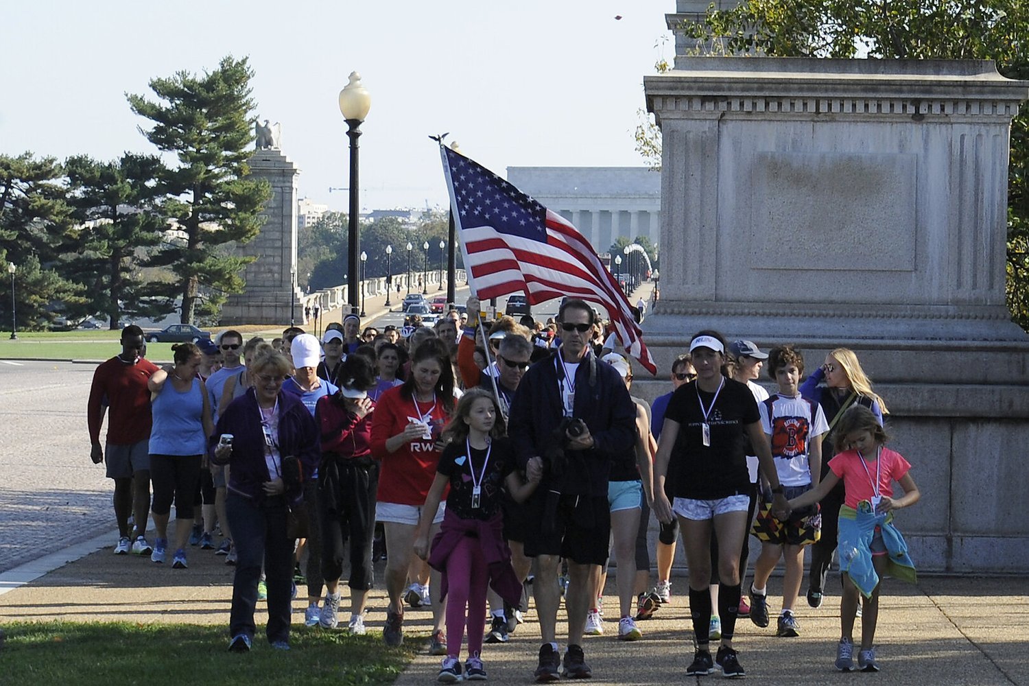 Nancy Lacore leading a group of 160 runners and walkers across the Memorial Bridge toward the Women's Memorial in Arlington, VA, during the final 1/4 mile of the inaugural 160-mile Valor Run in 2014.