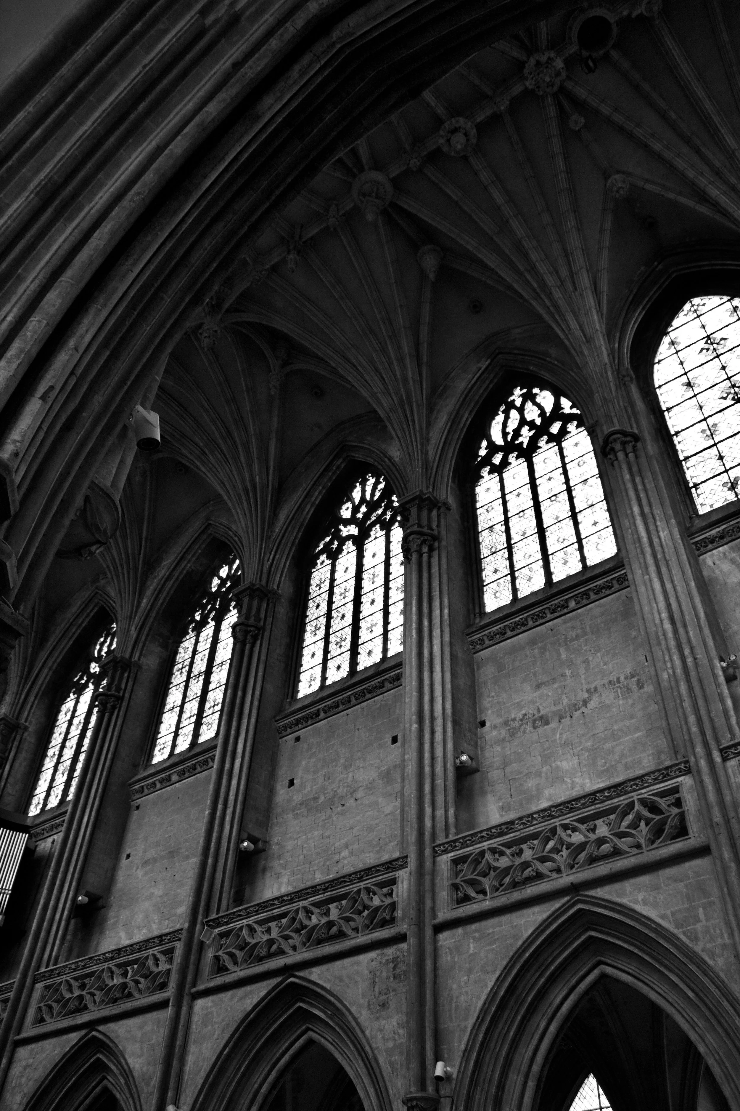 Interior view of a Gothic cathedral with high pointed arches and tall stained glass windows.