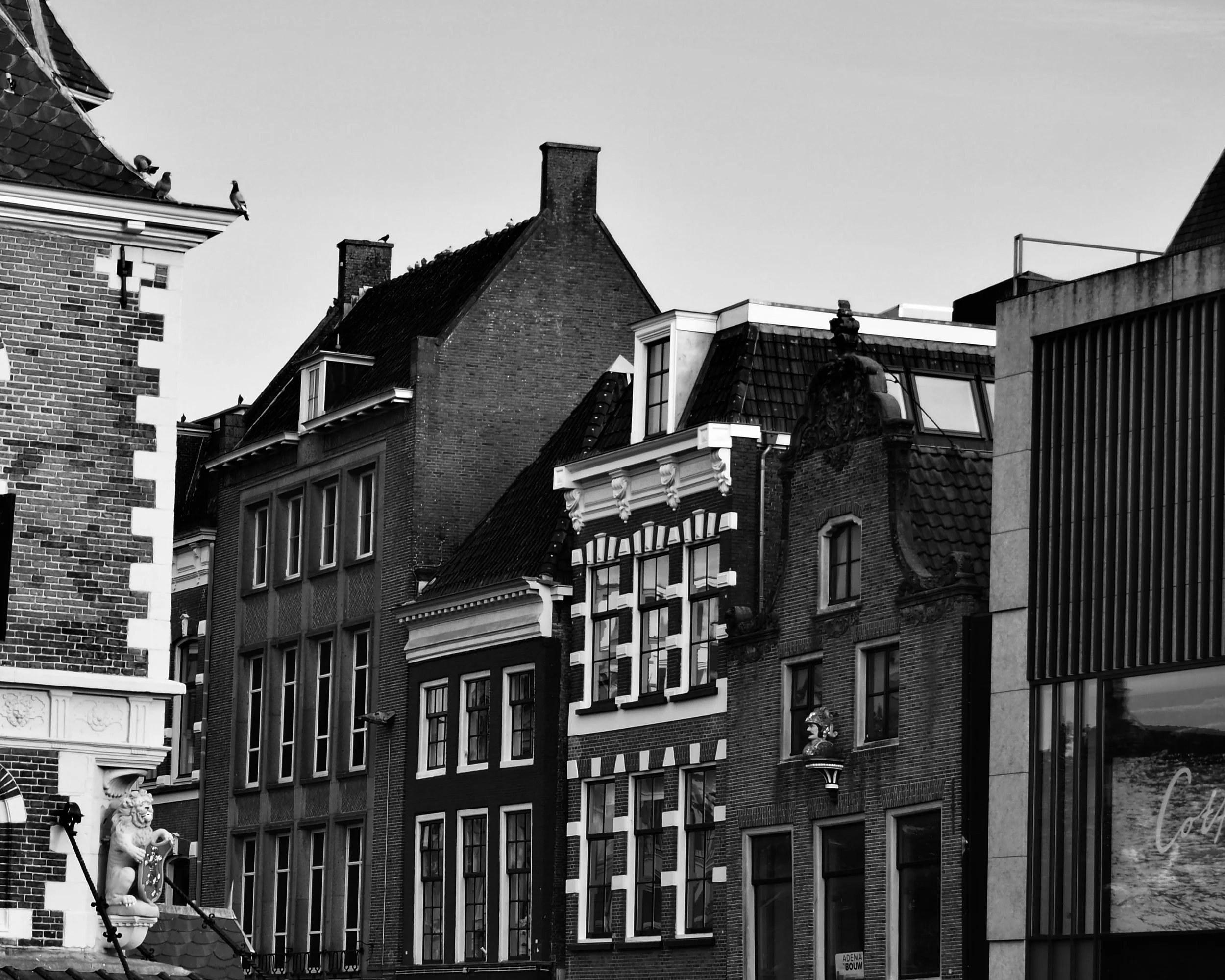 Black and white photo of historic European-style buildings with ornate facades and various roof styles.