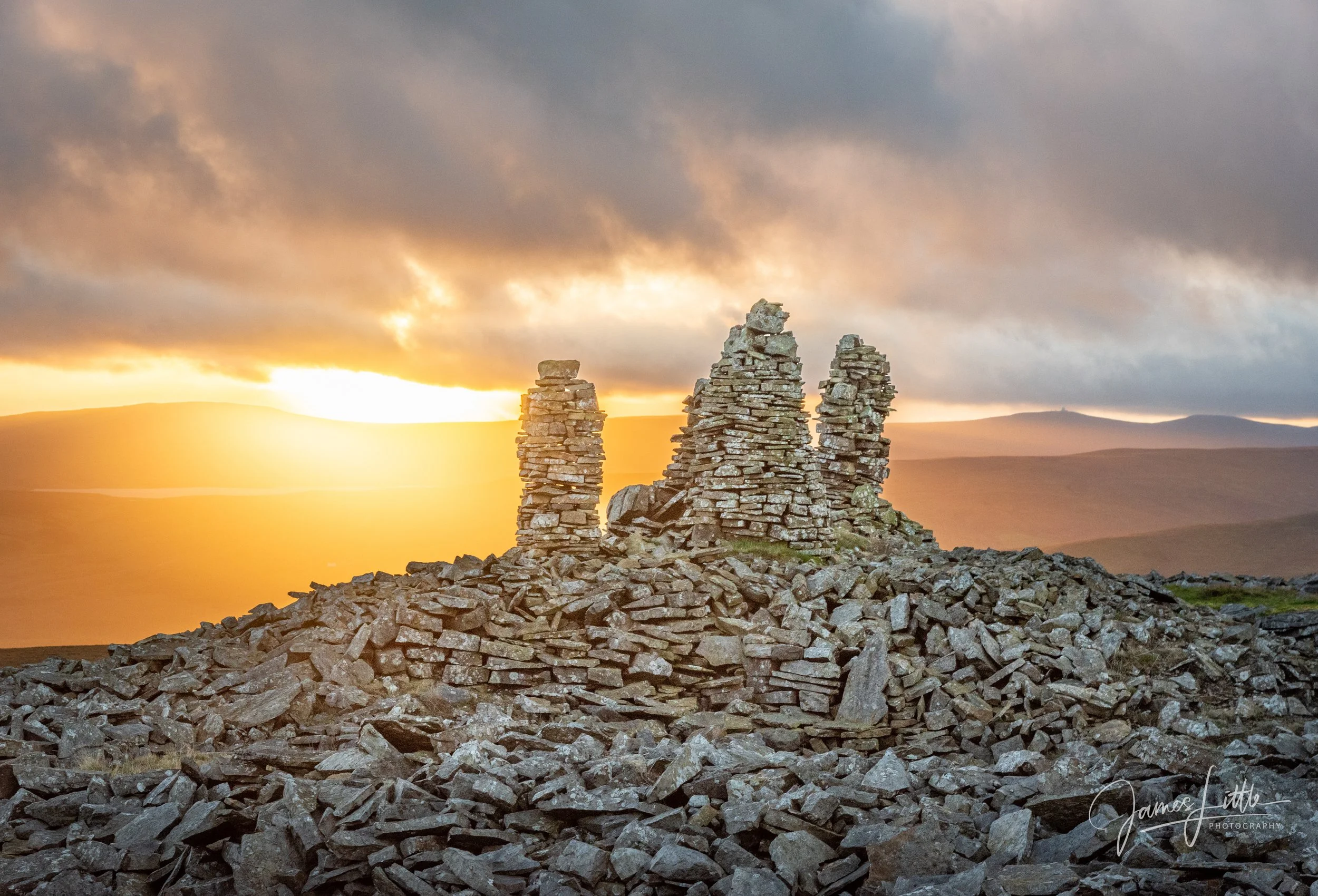 Three stone cairns over Cow Green Reservoir in the North Pennines AONB