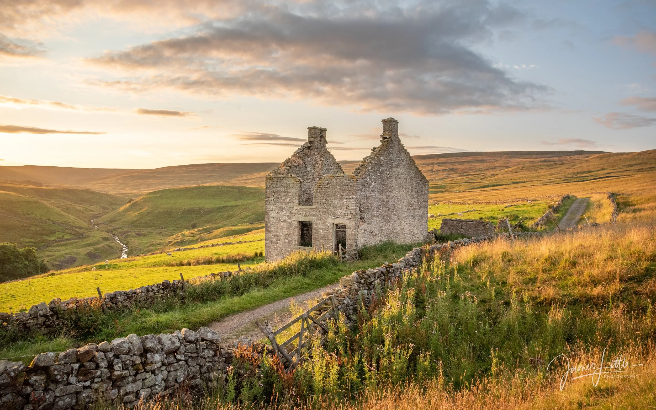 Ruined stone house in a green, hilly landscape at sunset with a cloudy sky. This old building near Westgate in County Durham made a great photo.