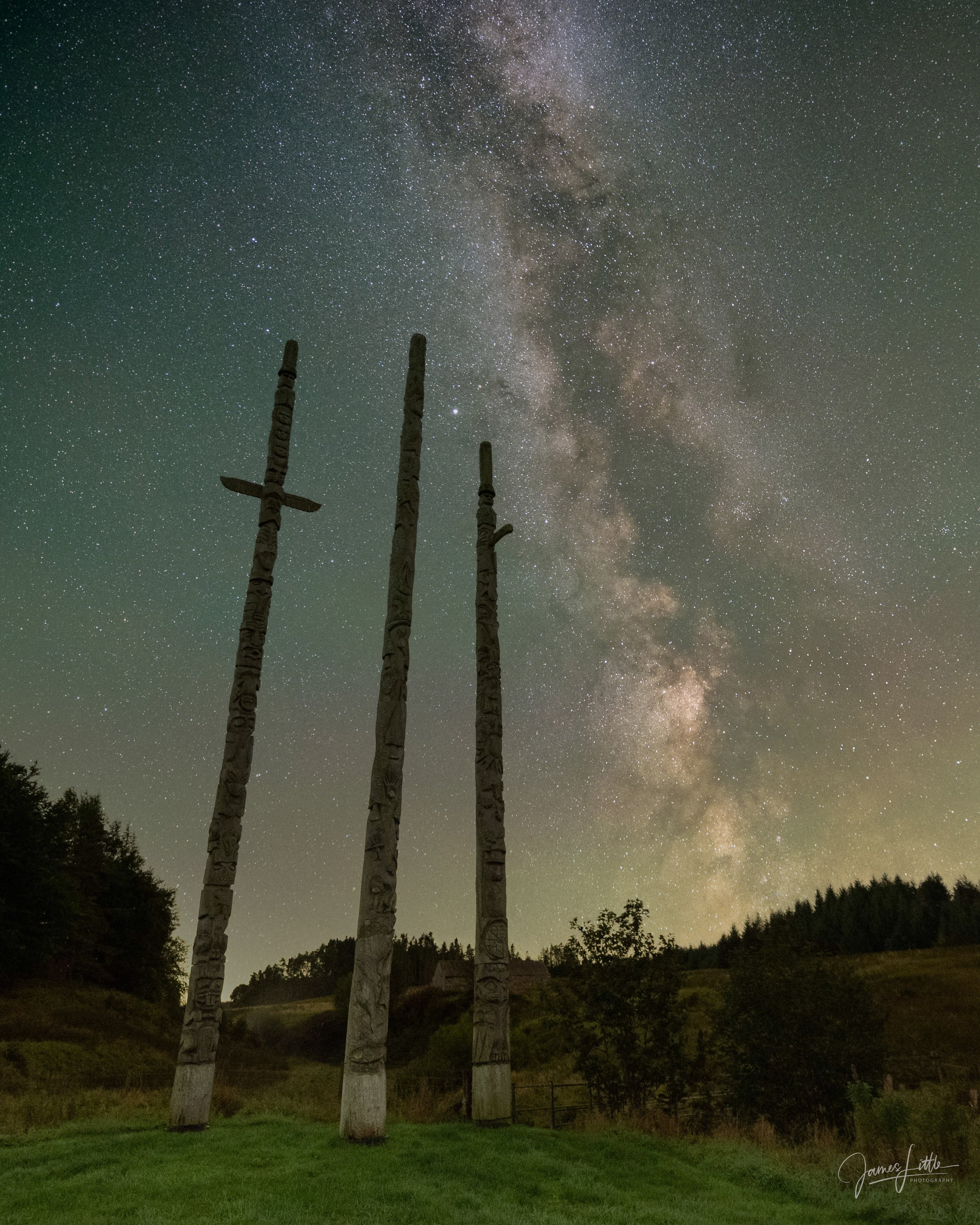 Stonehaugh totem pole under the milky way inside of Northumberland National Park.