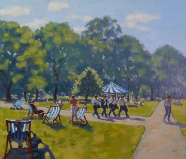 A park scene with trees, people walking, and a blue and white striped tent. Some people are sitting on deck chairs, while others are strolling or walking towards the tent.