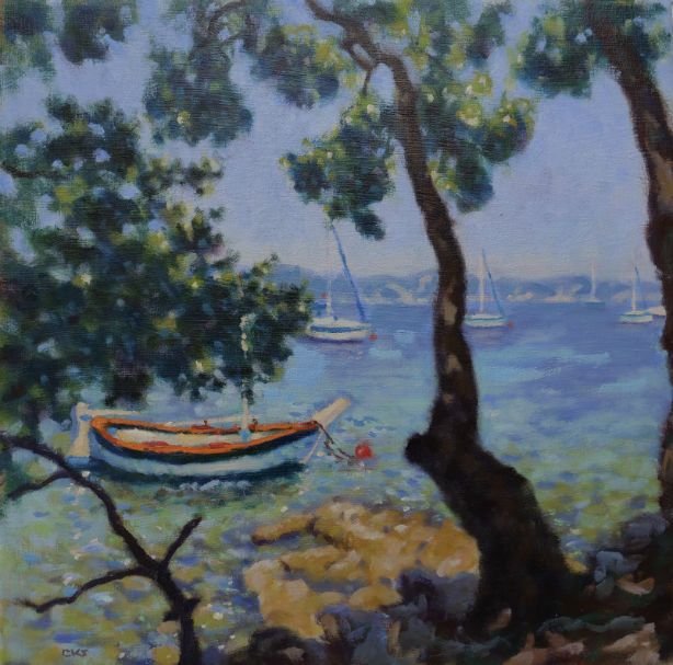 A peaceful lakeside scene with a boat floating near rocks, framed by trees with green foliage and sailboats on the distant water.