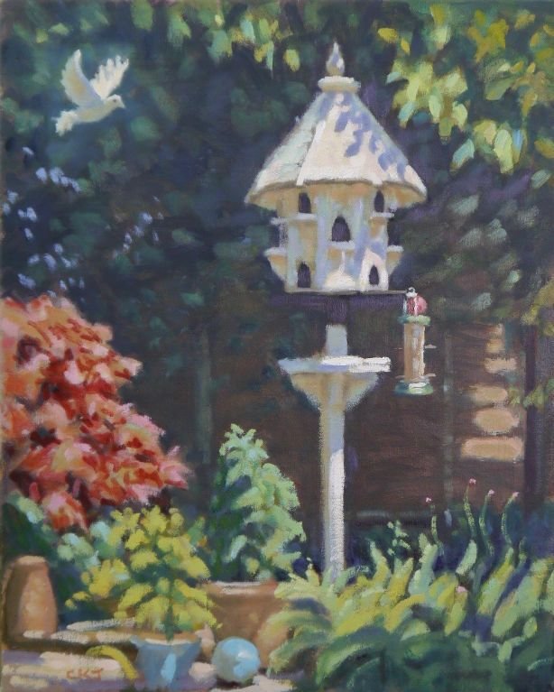 A painting of a garden scene featuring a birdhouse perched on a pole, surrounded by colorful flowers and lush greenery. A white bird is flying nearby.