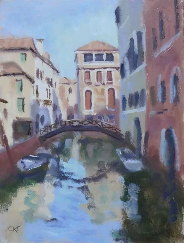 Painting of a canal in Venice with a small arched bridge, tall buildings on either side, and boats docked along the water.