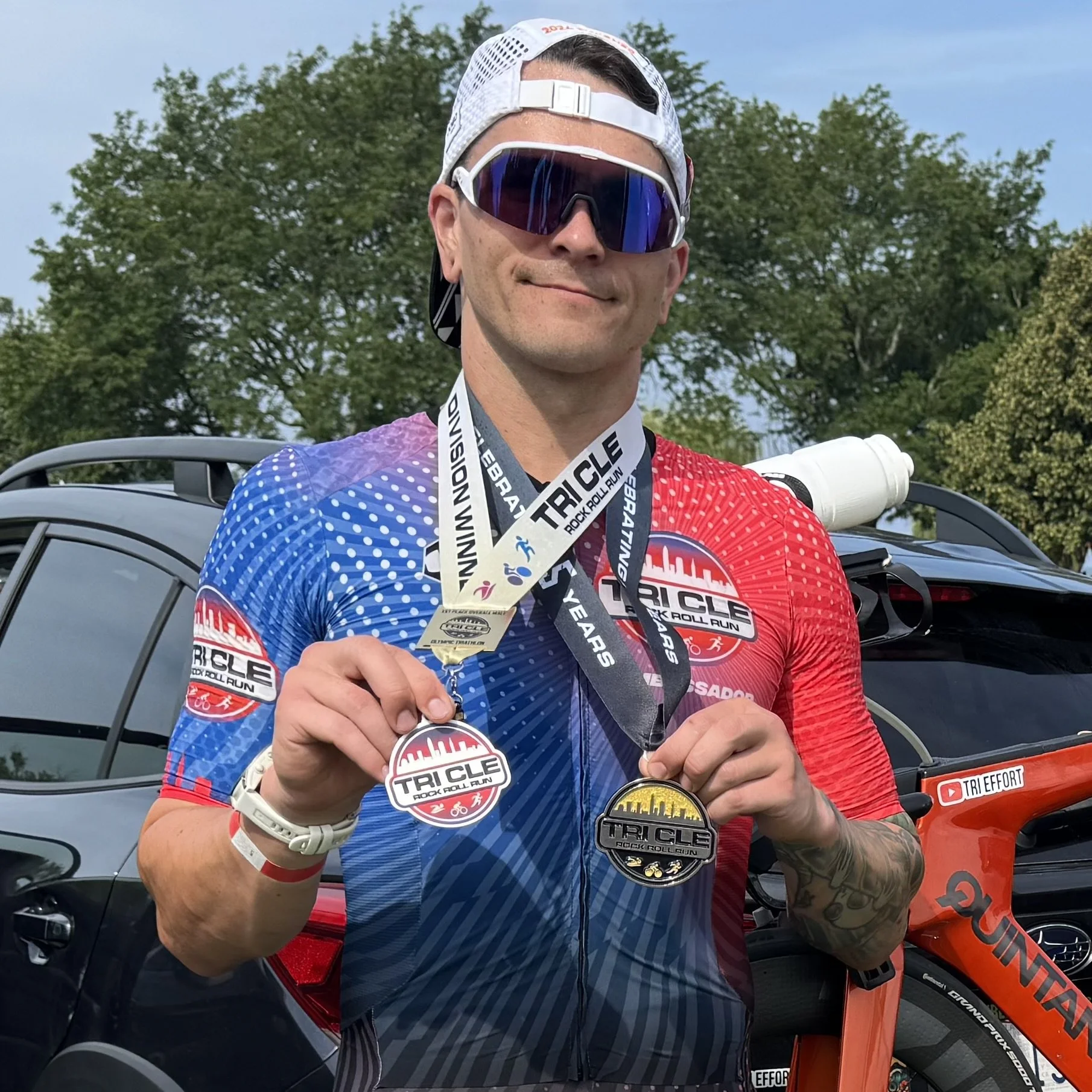 Ambassador Johnny holding his 2025 finisher medal and finisher award