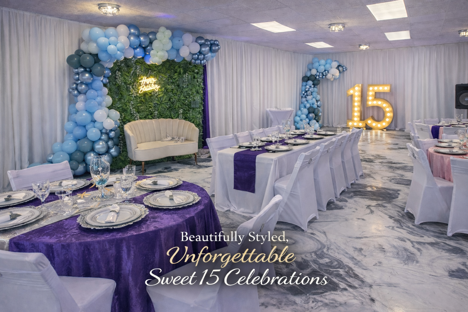 Decorated celebration hall with white and purple tablecloths, balloon arches in blue, white, and gray, large illuminated number 15, and a green leafy backdrop with 'Happy Birthday' neon sign.