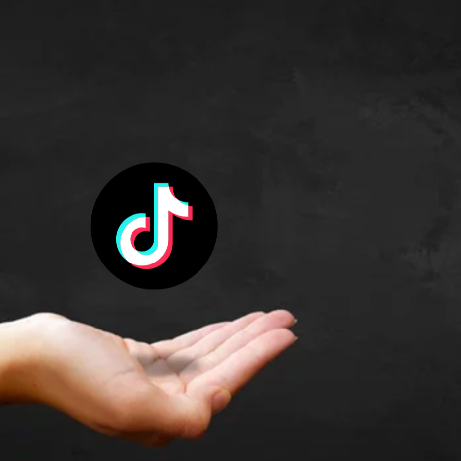 A hand with palm facing up under a floating TikTok logo against a black background.