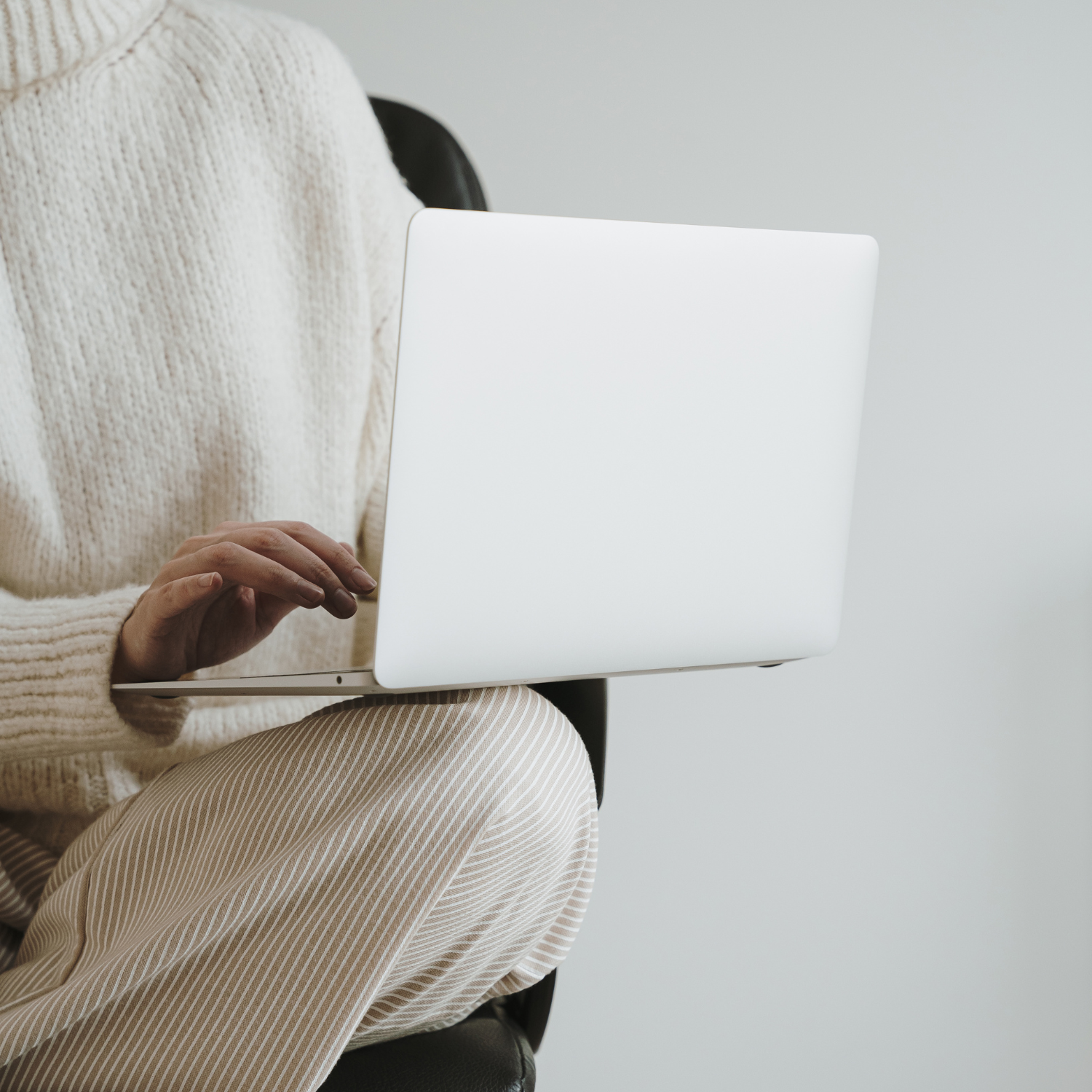 A women in career sitting with a laptop