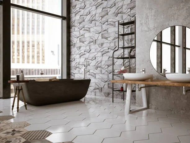 Modern bathroom with a black bathtub, a large window, geometric white tile floor, a textured stone wall, a wooden double sink vanity with circular sinks, a round mirror, and a metal storage rack.