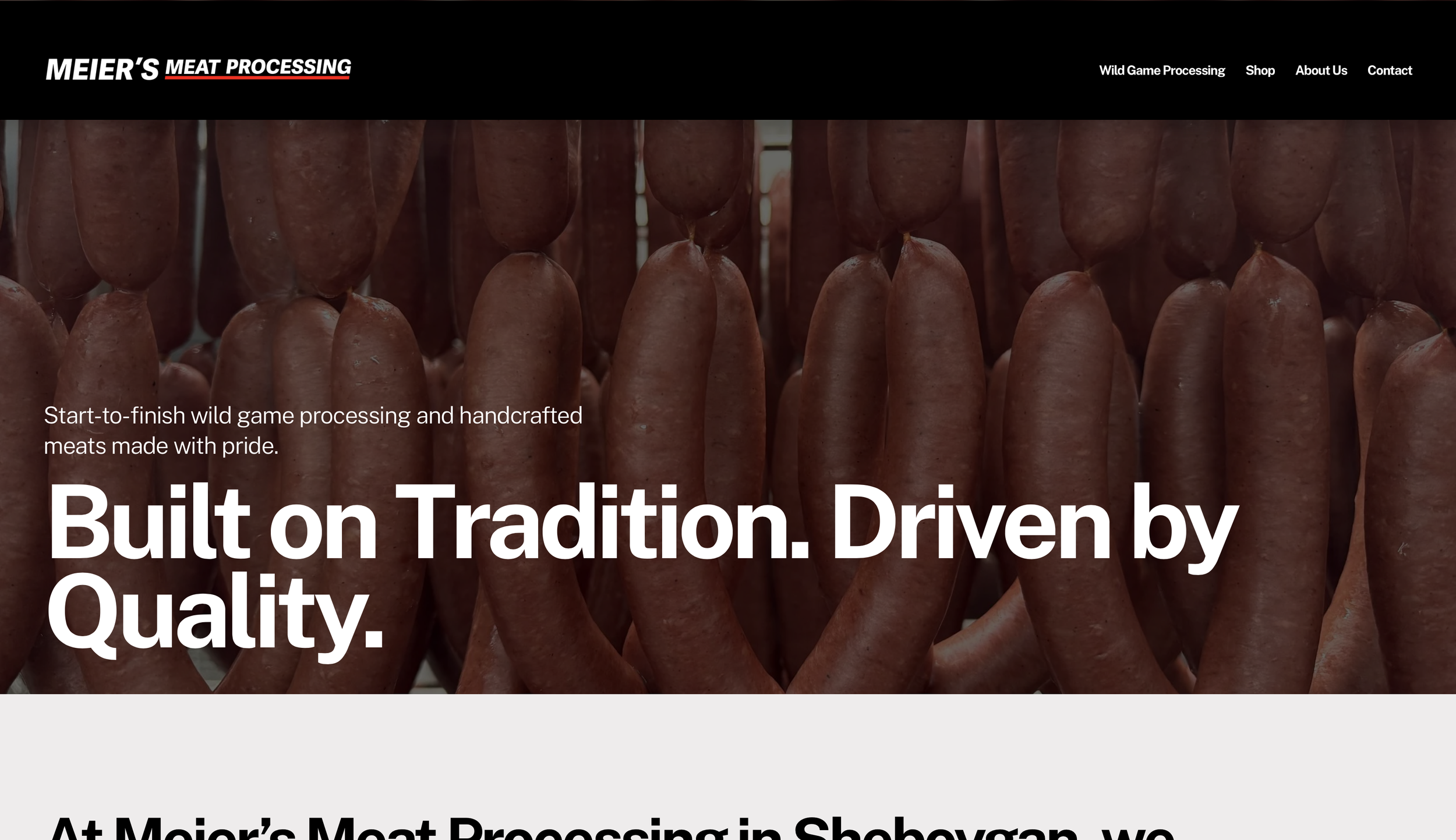 Close-up of hanging uncooked sausages at a meat processing facility.