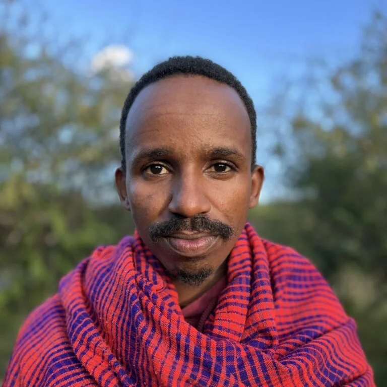 William Naimado a Maasai youth from Kenya in traditional wool