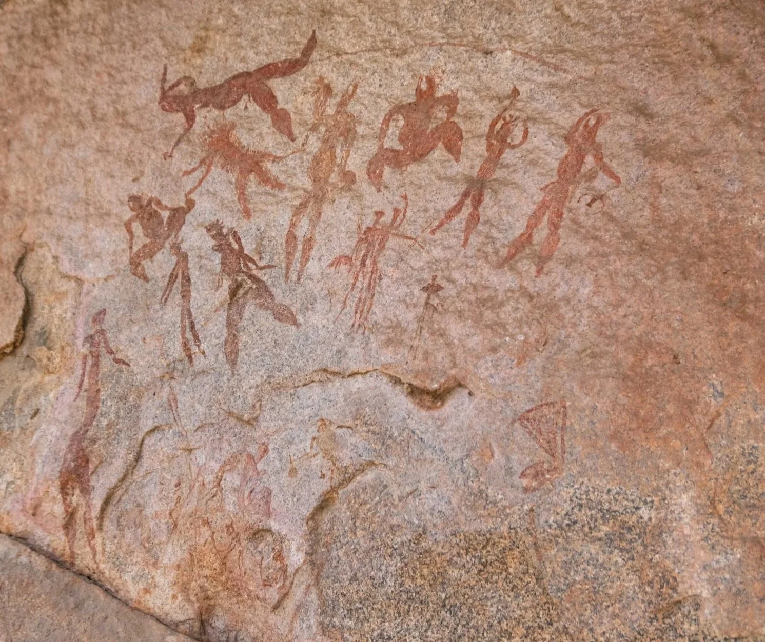 Ancient cave painting depicting various human figures which are half human half crocodile