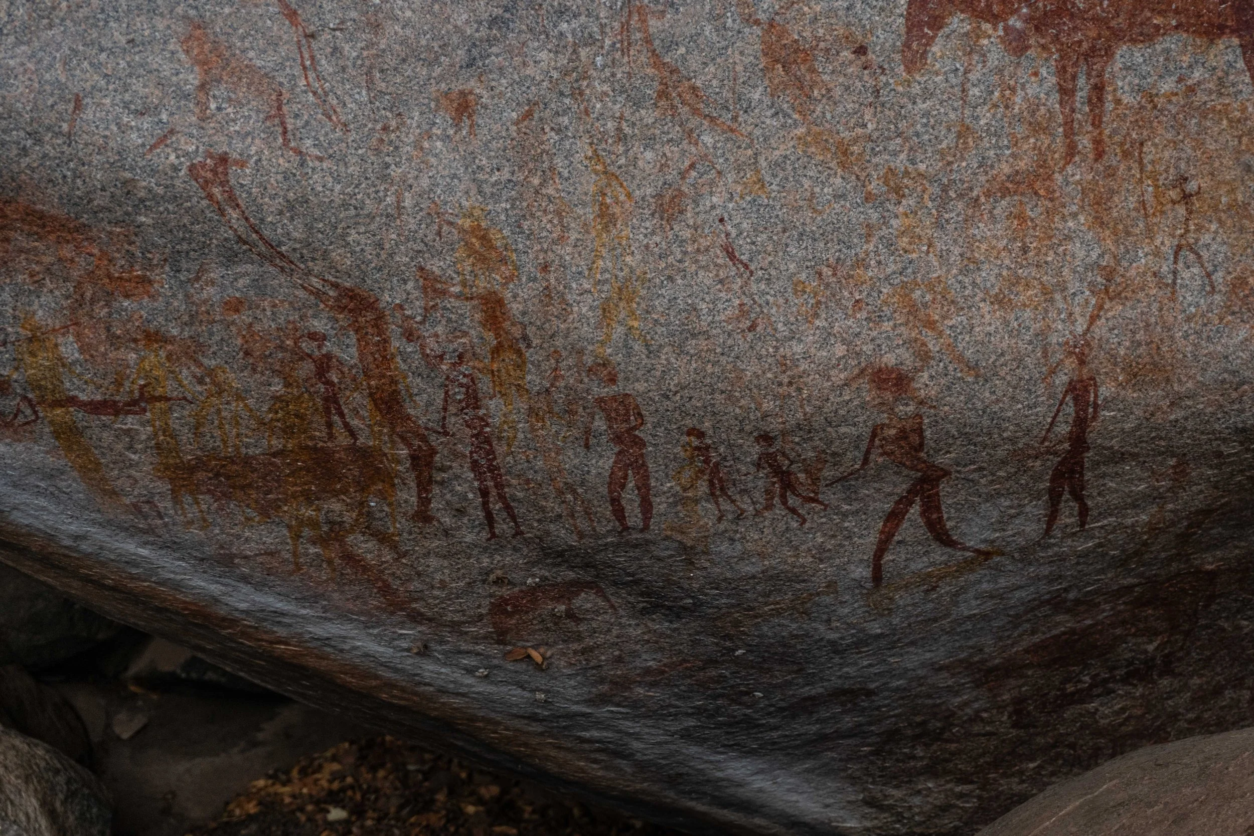 Ancient cave paintings depicting human figures and animals.