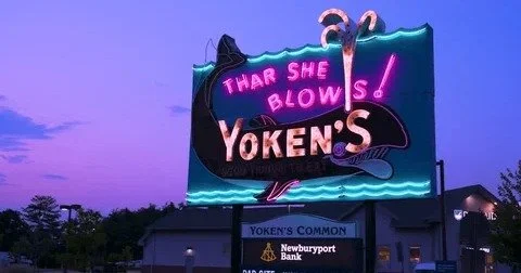 Remember cruising Route 1 through Portsmouth, NH, and spotting that massive neon whale spouting "Thar She Blows!" atop Yoken's? The iconic sign glowing pink and blue against the dusk sky, promising "GOOD THINGS TO EAT" and pulling