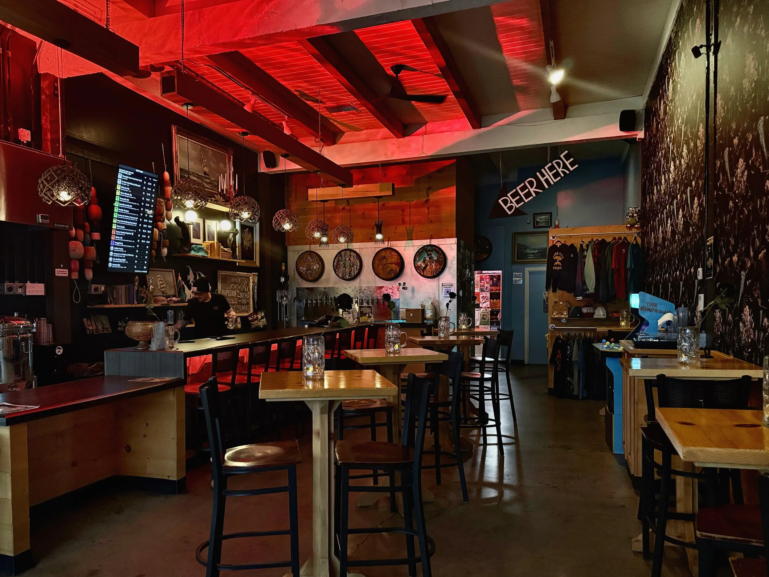 View of Smog City West high-top seating area in the middle of the taproom.