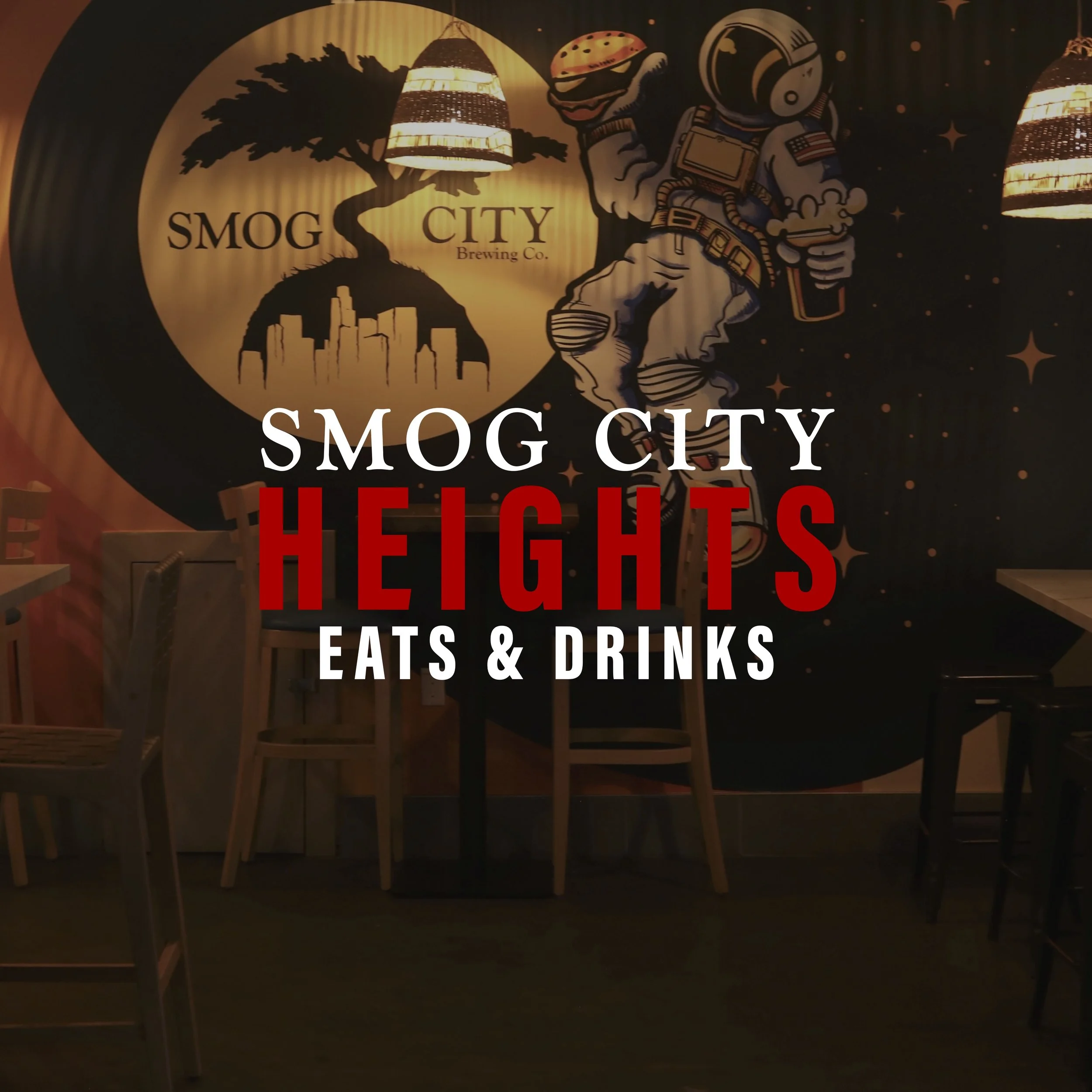 Decorative wall mural with the text "Smog City Heights Eats & Drinks," featuring a cartoon astronaut holding a burger and a beer, a silhouette of city buildings, a tree, and hanging lights in a restaurant setting.
