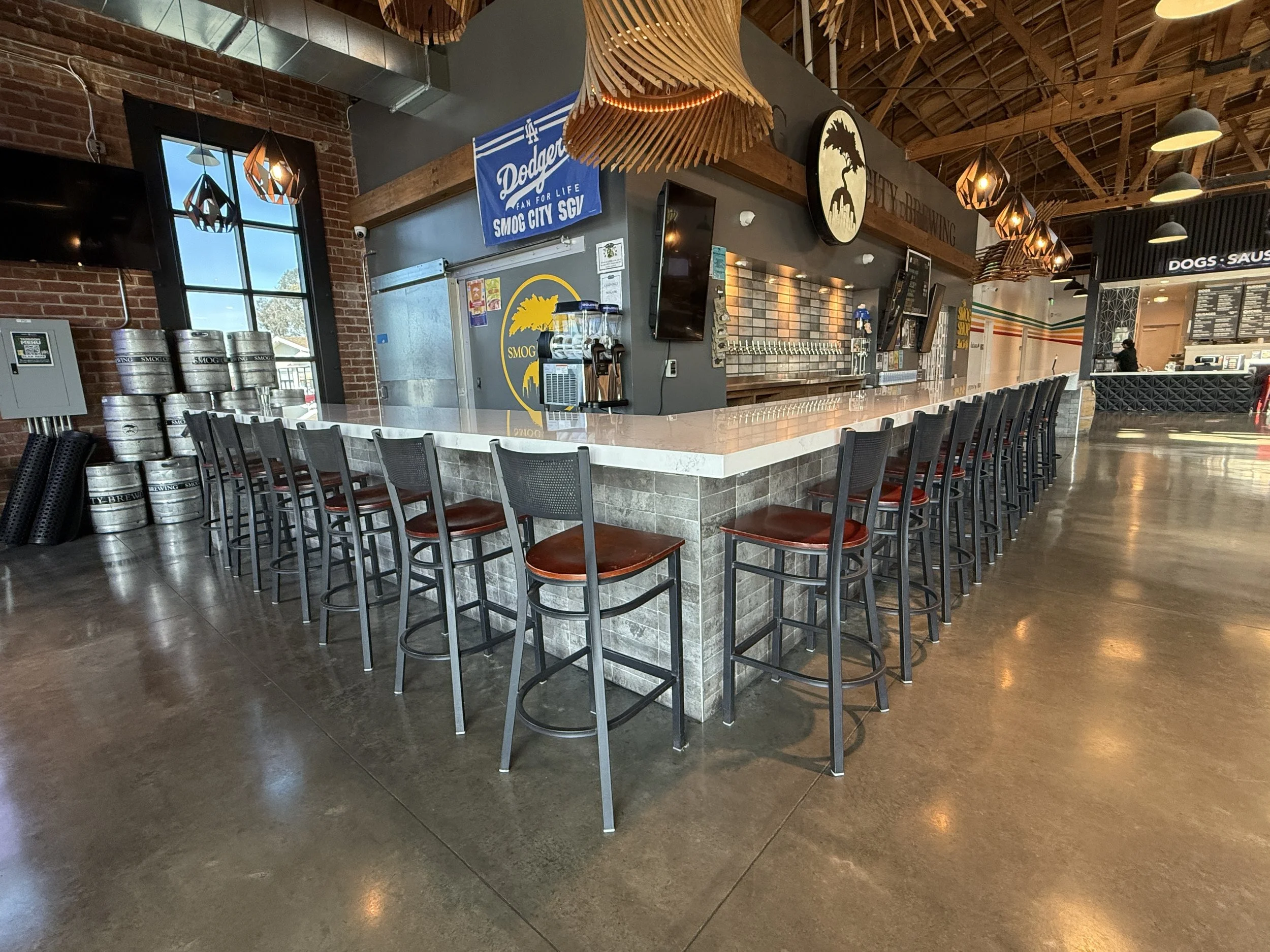 View of the bar at Smog City Glendora with stools wrapping around two sides.