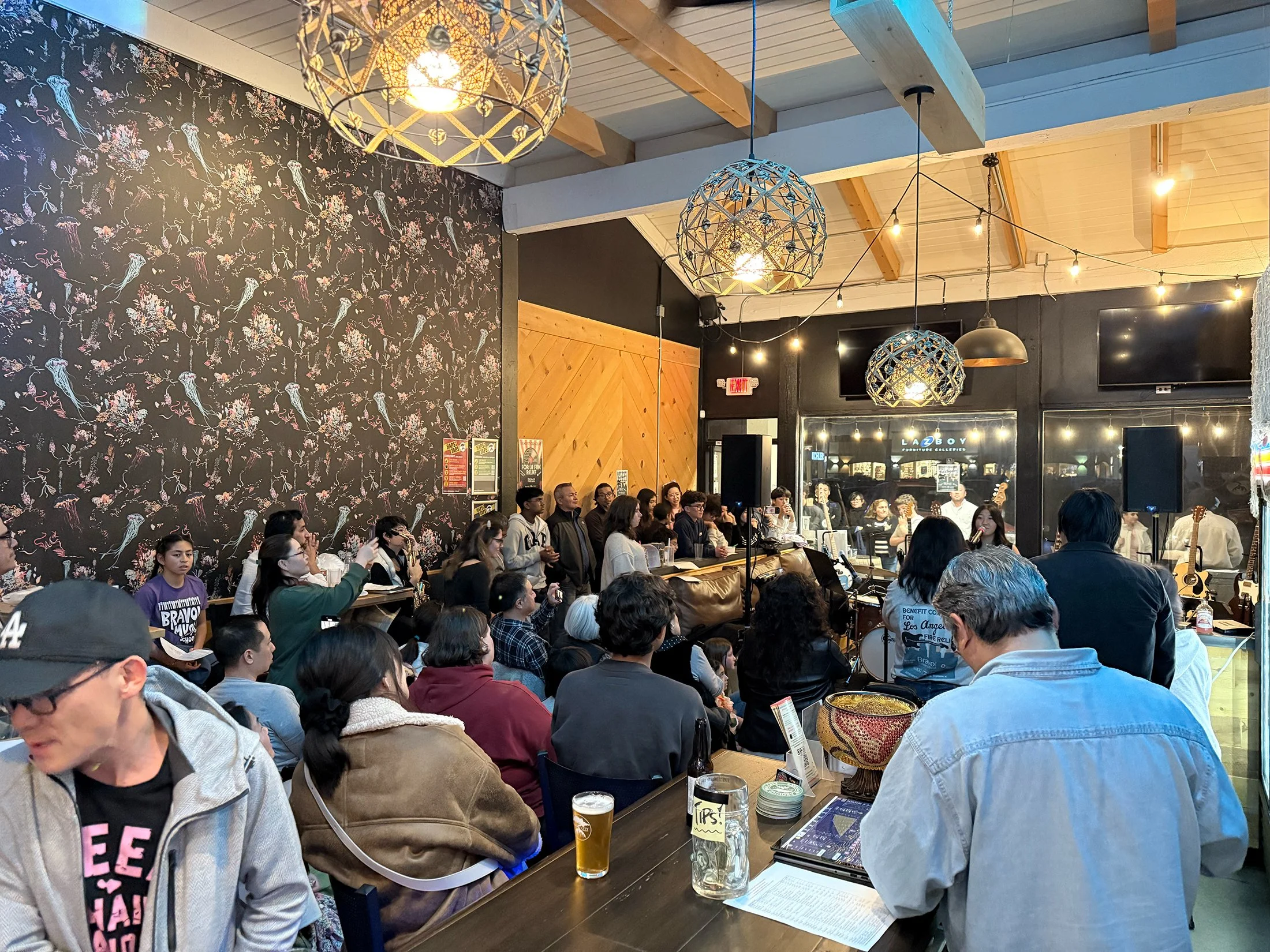 Guests in the taproom during a live band performance.