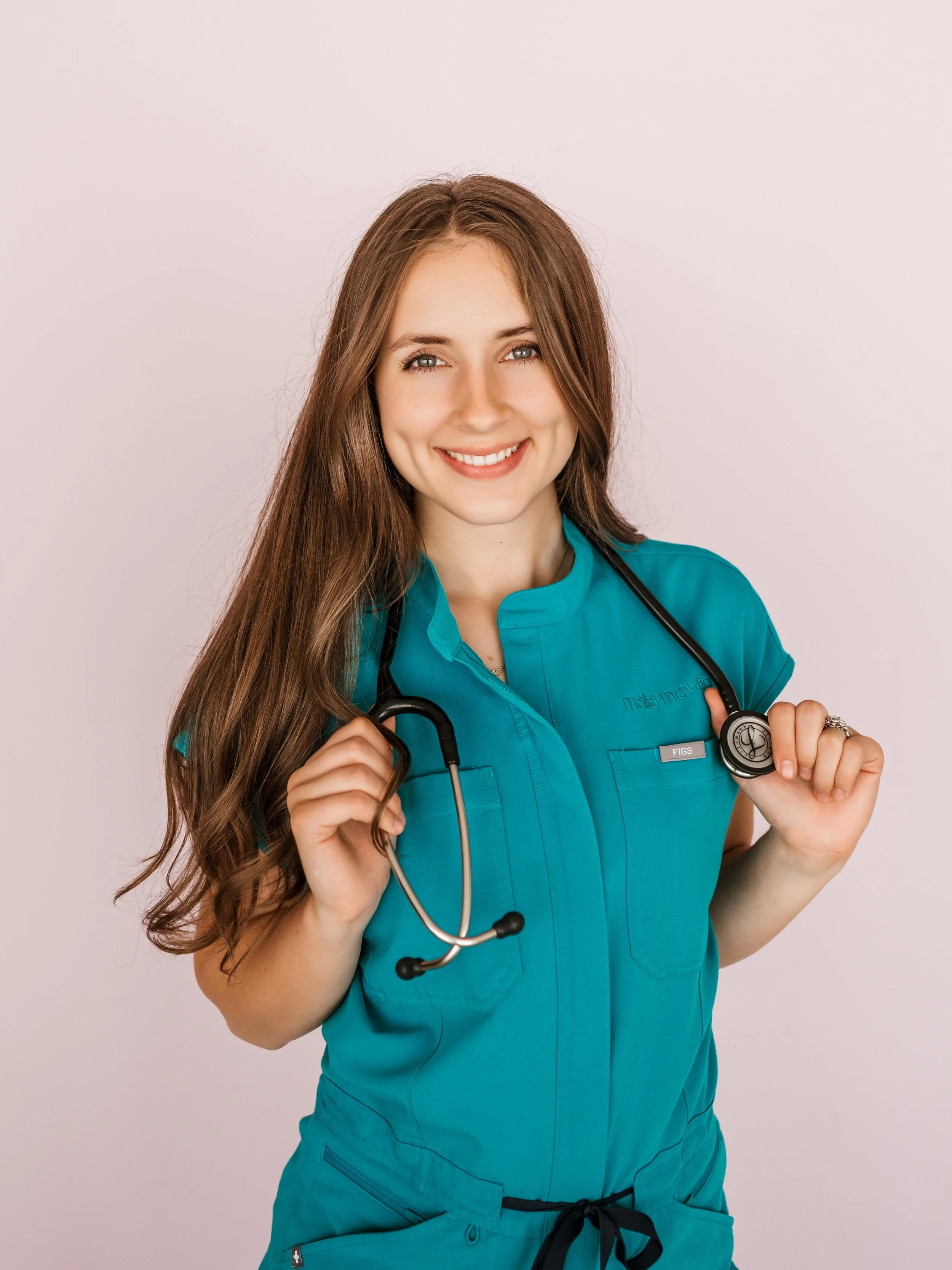 A young female nurse or medical professional with long brown hair, wearing turquoise scrubs and holding a stethoscope.