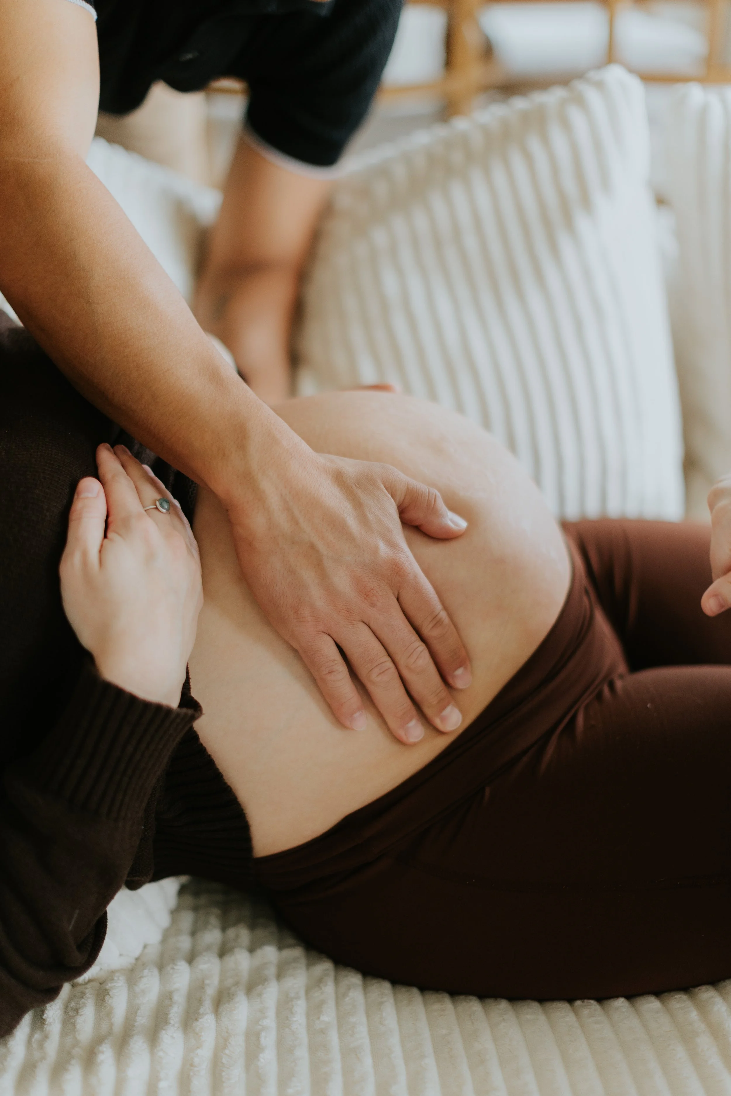A father feels his unborn baby move at a Lubbock Texas prenatal visit.