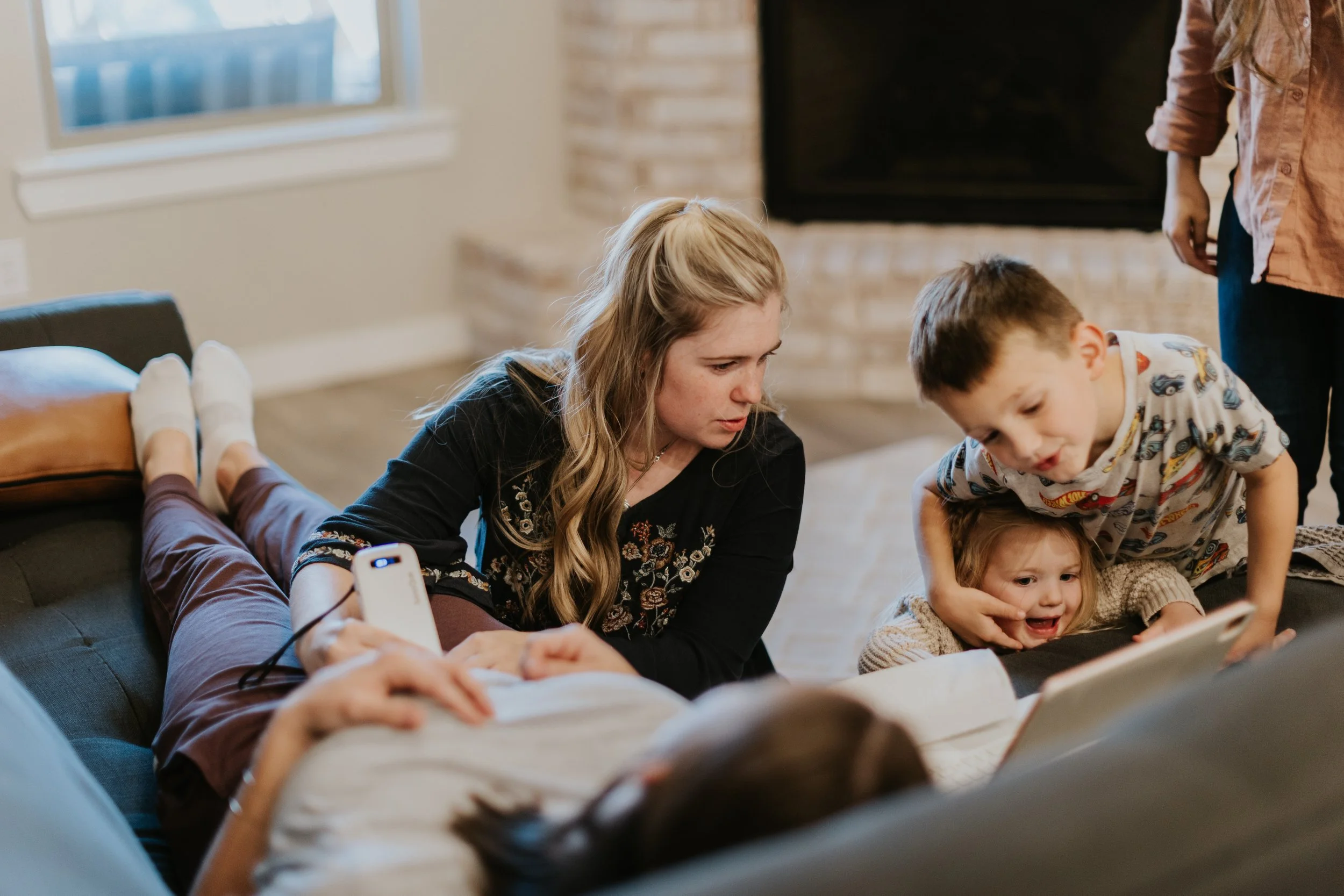 Older siblings watch on as a home birth midwife conducts a prenatal visit in Lubbock Texas..