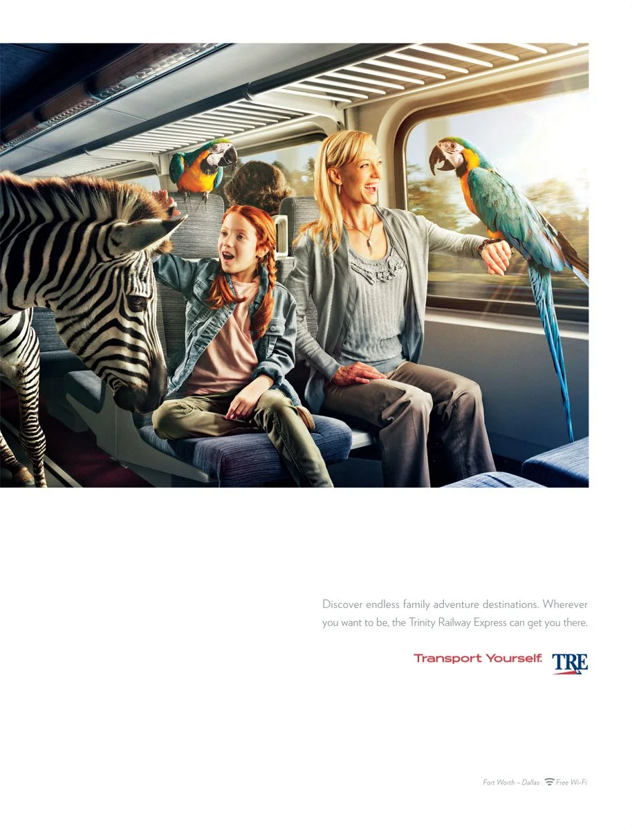 A woman and a girl sitting on a train, surrounded by a zebra, two parrots and a background that appears to be traveling through scenic landscape.