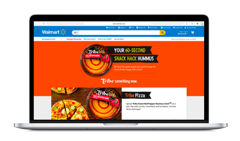 Laptop screen displaying Walmart website with an advertisement for Tribe snack hack hummus and pizza.