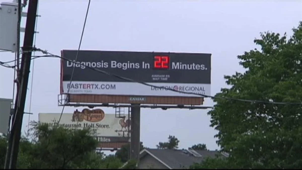 A digital billboard displaying a message 'Diagnosis Begins In 22 Minutes' with a countdown timer and website URL.